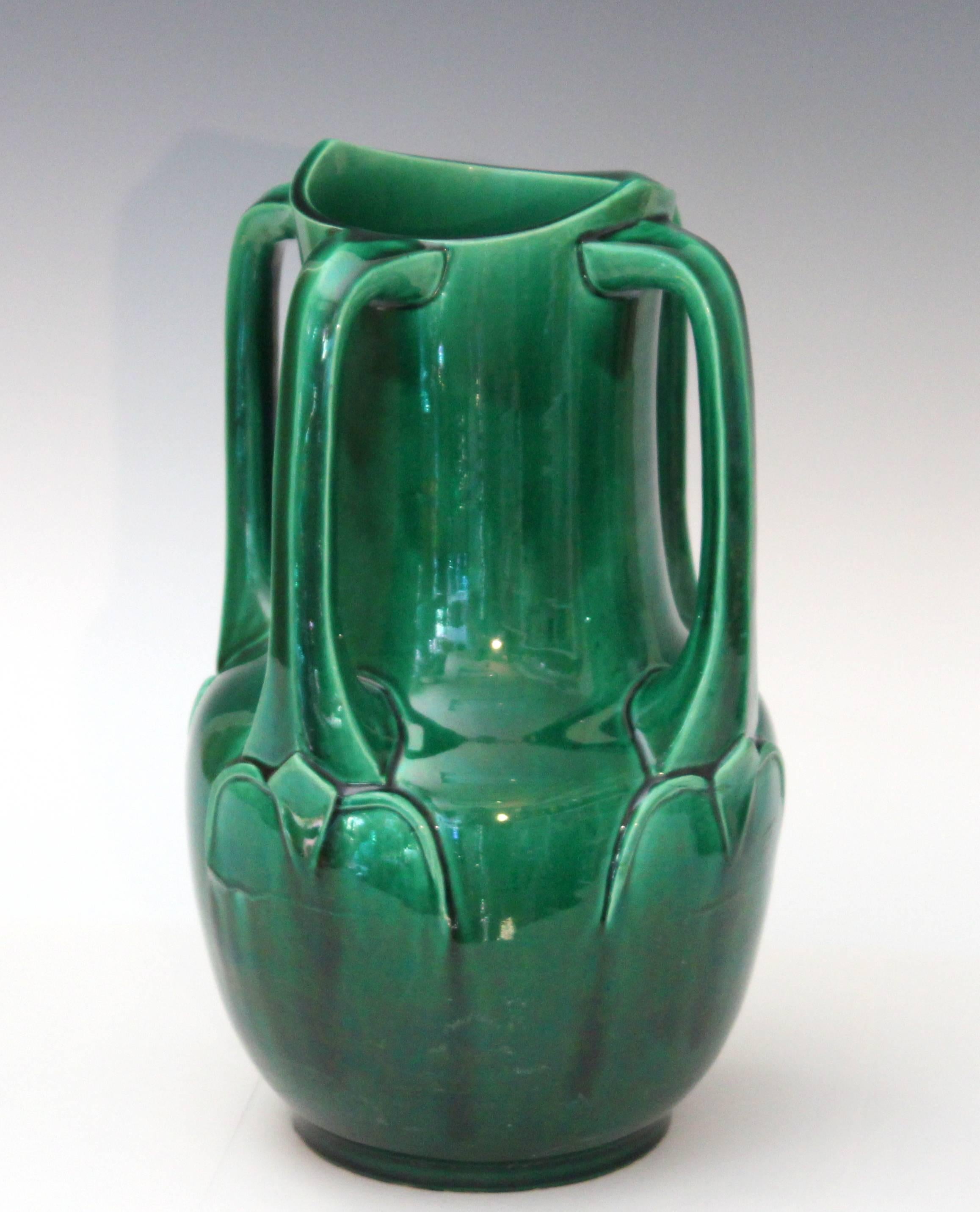 Awaji Pottery vase in architectural Art Nouveau form with four applied buttress handles and deep green monochrome glaze, circa 1910s. Measures: 12" high, 8" diameter. Good vintage condition, small chip to "ear" at rim repaired,