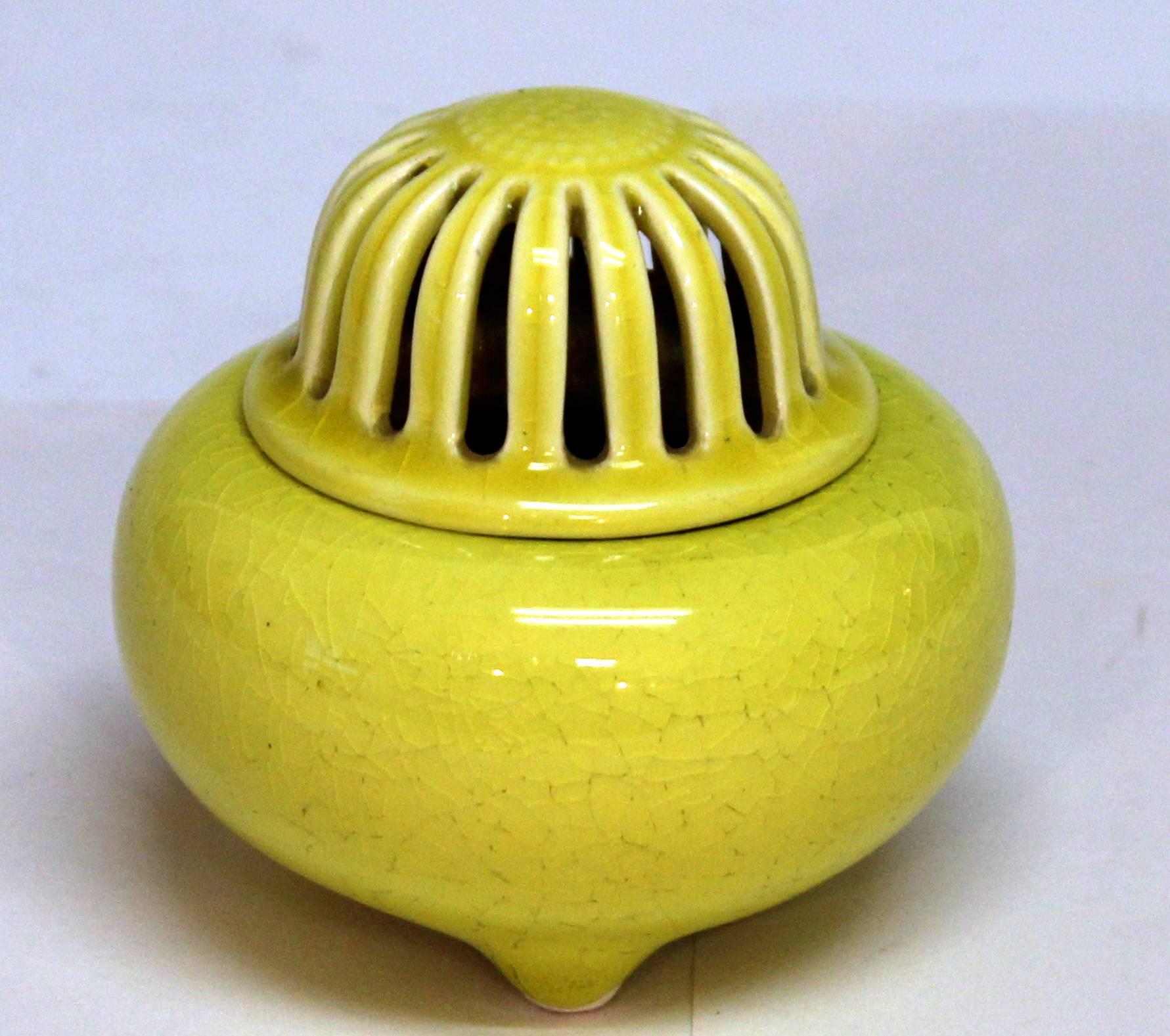 Kyoto pottery tripod censor with pierced cover in the form of a blossom and bright yellow crackle glaze, circa early 20th century. Measures: 3