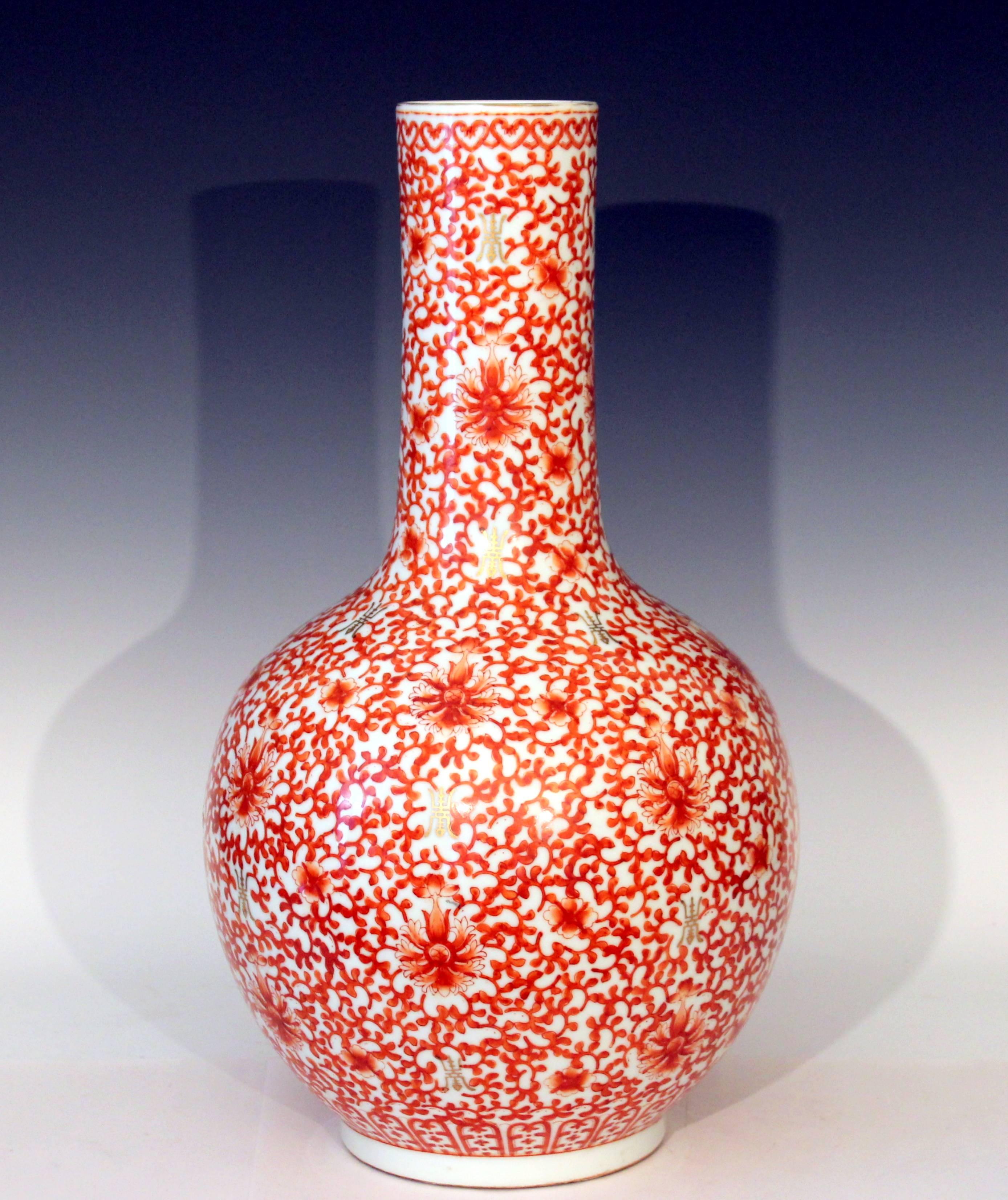 Large vintage Chinese porcelain bottle form vase, drilled for lamp, circa 1960s. Decorated in iron red lotus scrolls with gilt shou (longevity/health) symbols. Measures: 19 1/2