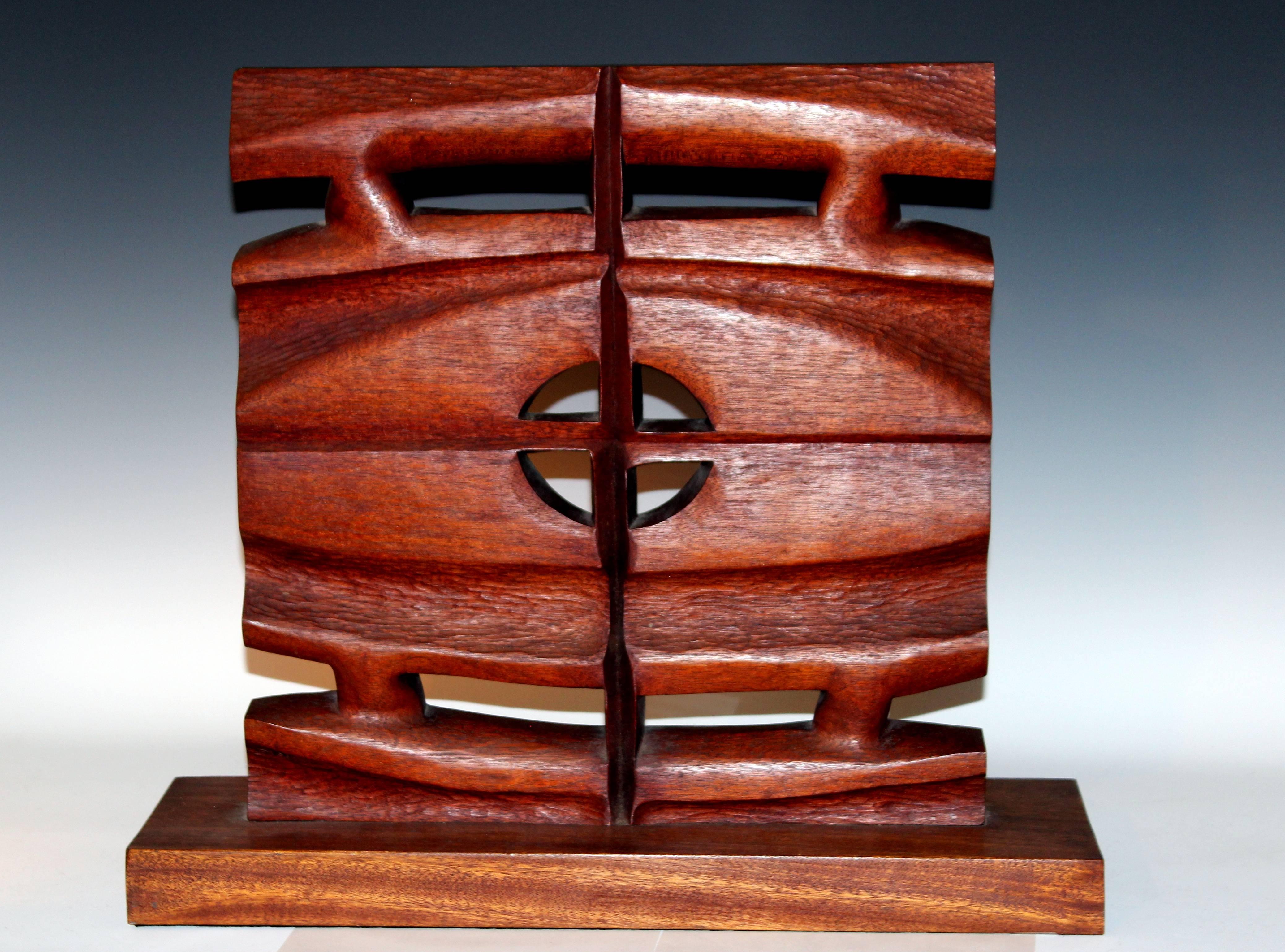 Jane McClintock totemic sculpture carved from a single large slab of mahogany and fitted with a rectangular base. Dated 1968. 20