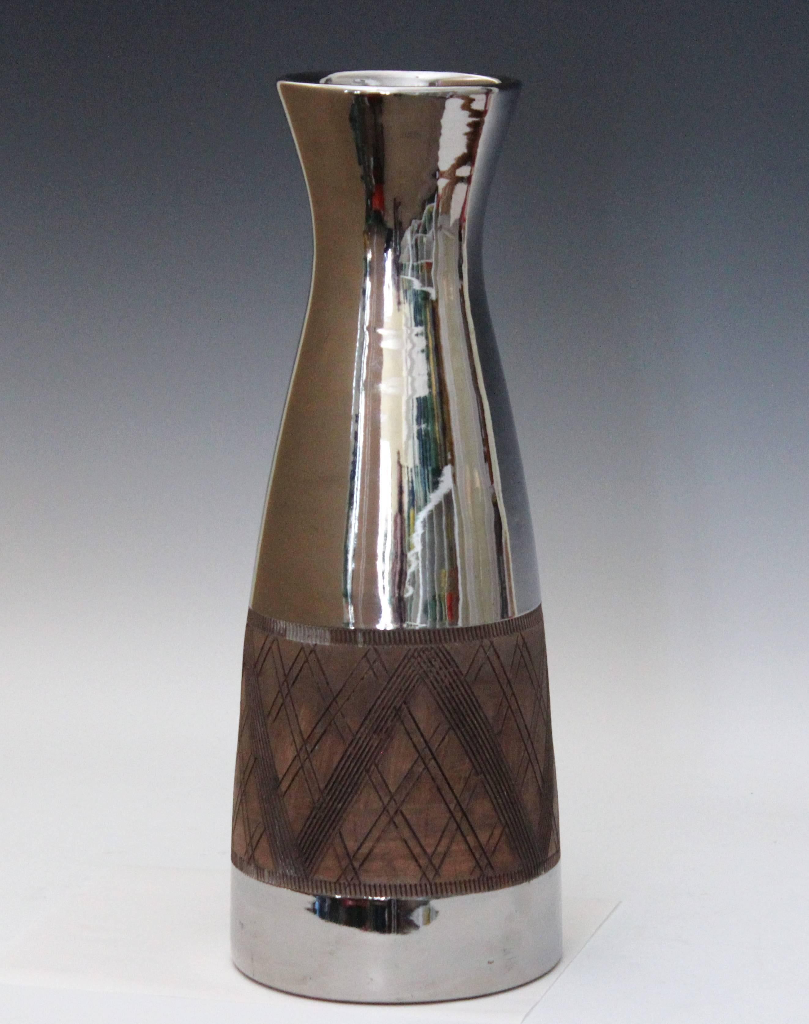 Big, sleek Bitossi pottery vase in lustrous platinum glaze, circa late 1950s-early 1960s. Hand turned with red clay and with incised cross hatching between gear tooth bands. Bitossi inventory label on base. Measures: 17" high, 6 1/2"