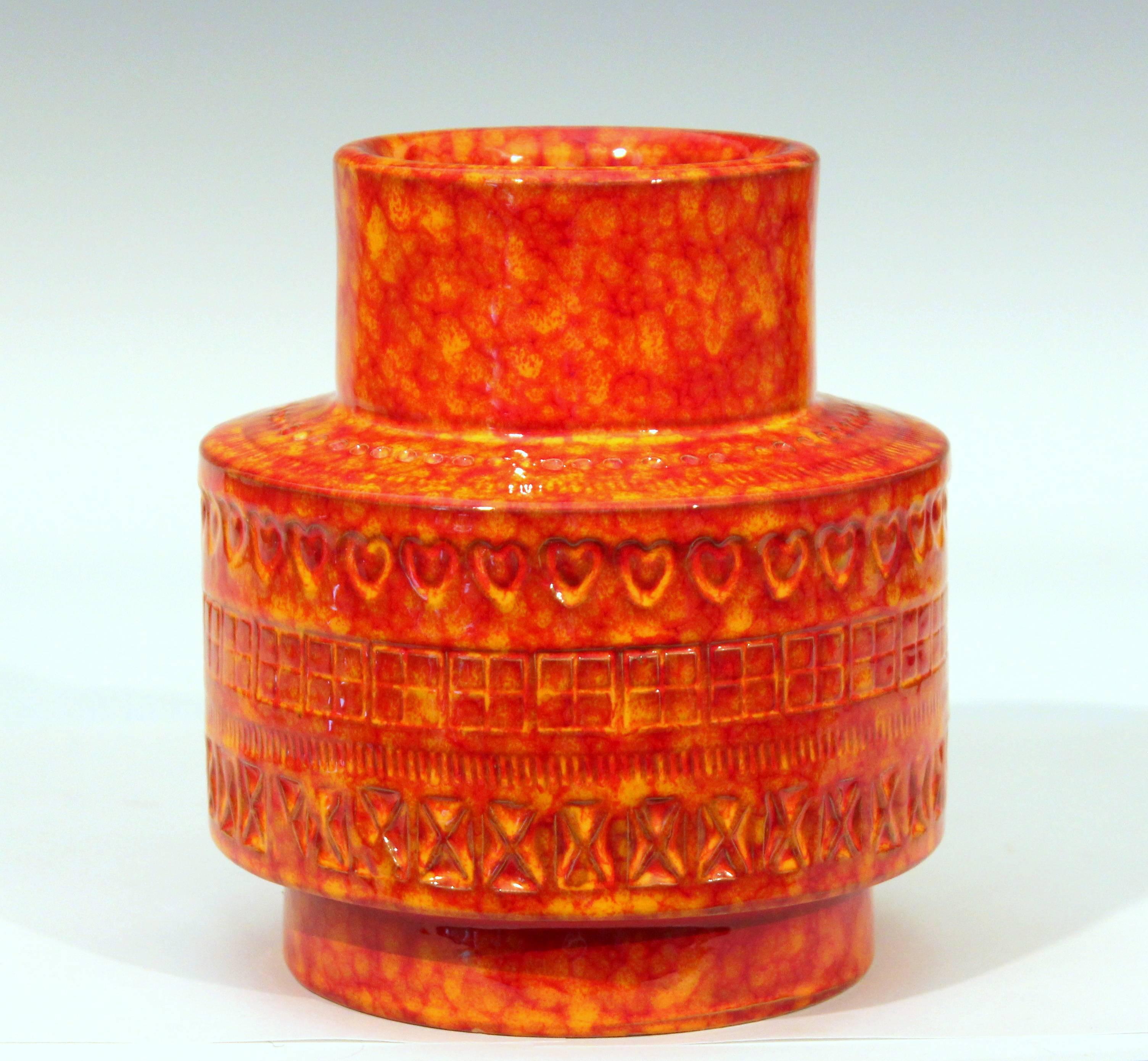 Vintage hand-turned Bitossi vase in stovepipe form with impressed Rimini decor on a bright red and yellow mottled glaze ground, circa 1960s. Measures: 6 1/2