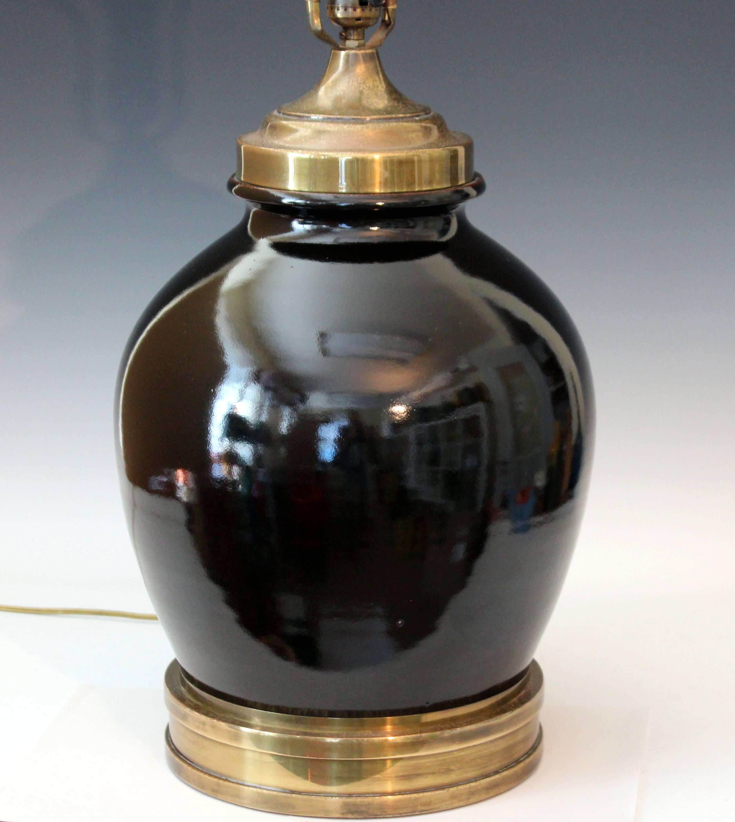 Large hand-turned mirror black lamp with heavy brass hardware by Hart Associates, circa 1960s. Measures: 34" high overall, 21" to socket, 11" diameter. Excellent condition, two tiny dings to glaze, as shown.