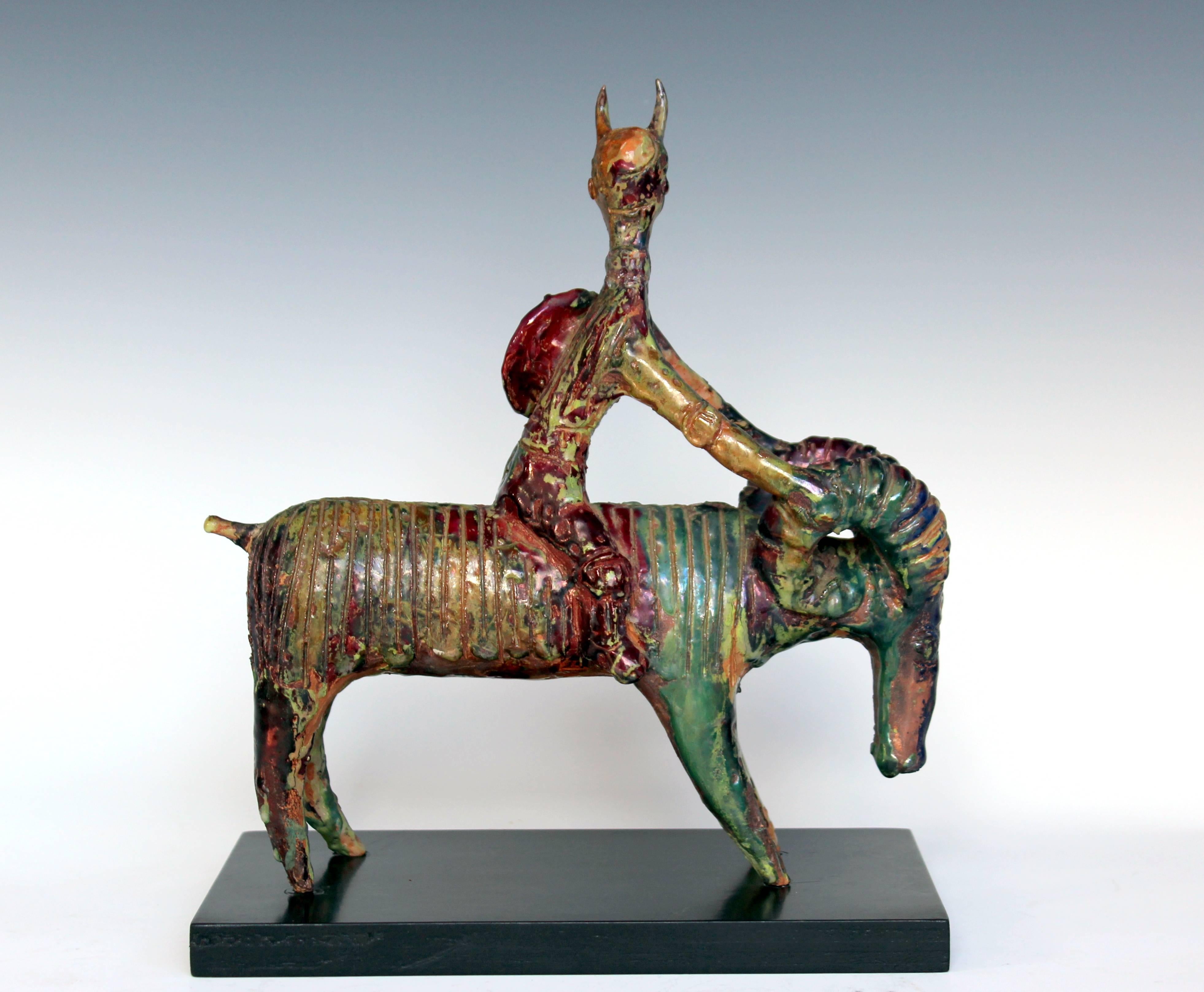 Extraordinary ceramic sculpture by renowned Italian artist, Gavino Tilocca. Circa 1960. Depicting a warrior figure with horns and shield riding a ram. 11 