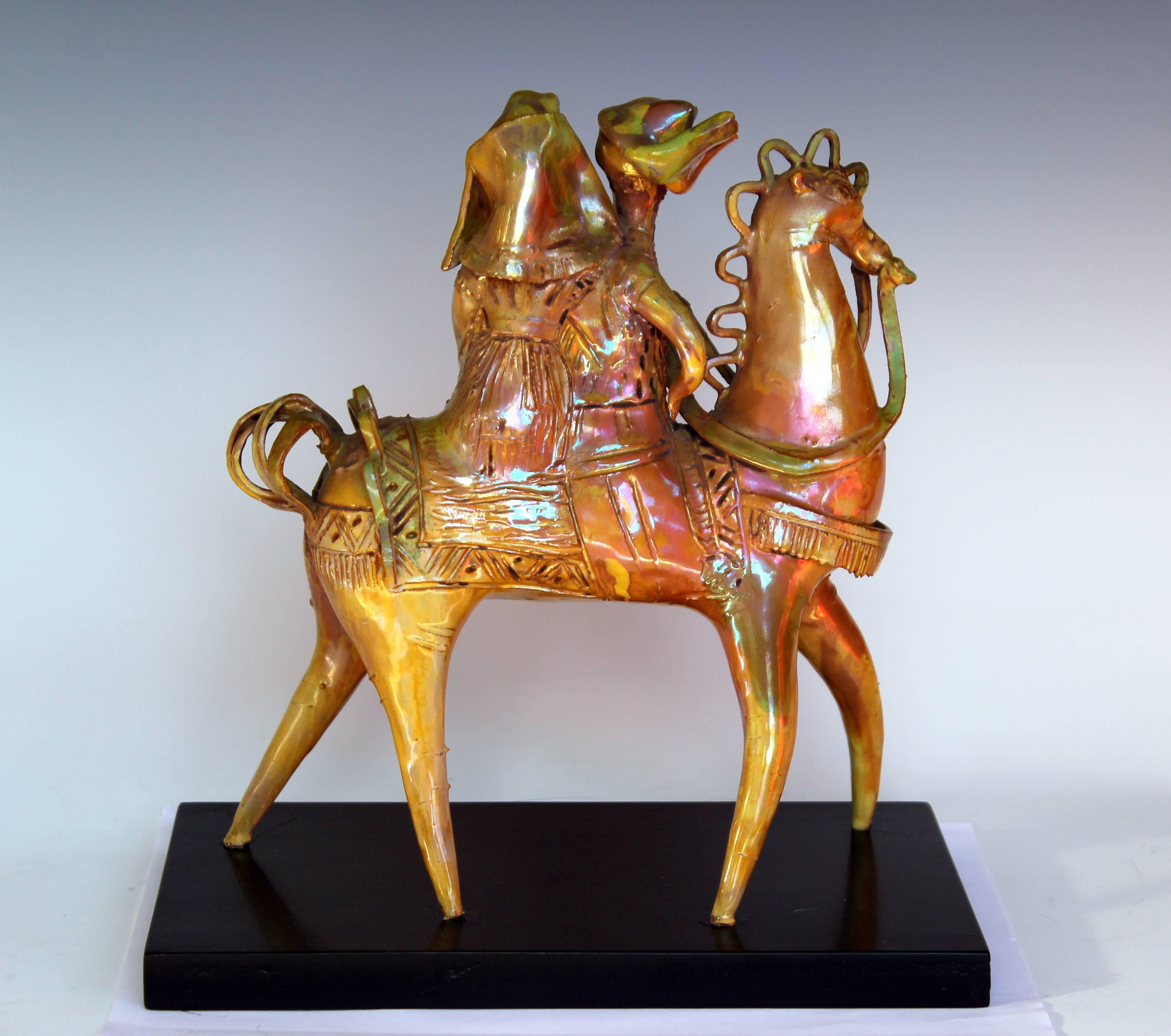 Extraordinary ceramic sculpture by renowned Italian artist, Gavino Tilocca, circa 1960. Depicting a couple in local Sardinian dress atop a horse wonderfully fitted out for a procession or ceremony. Measures: 9 3/4