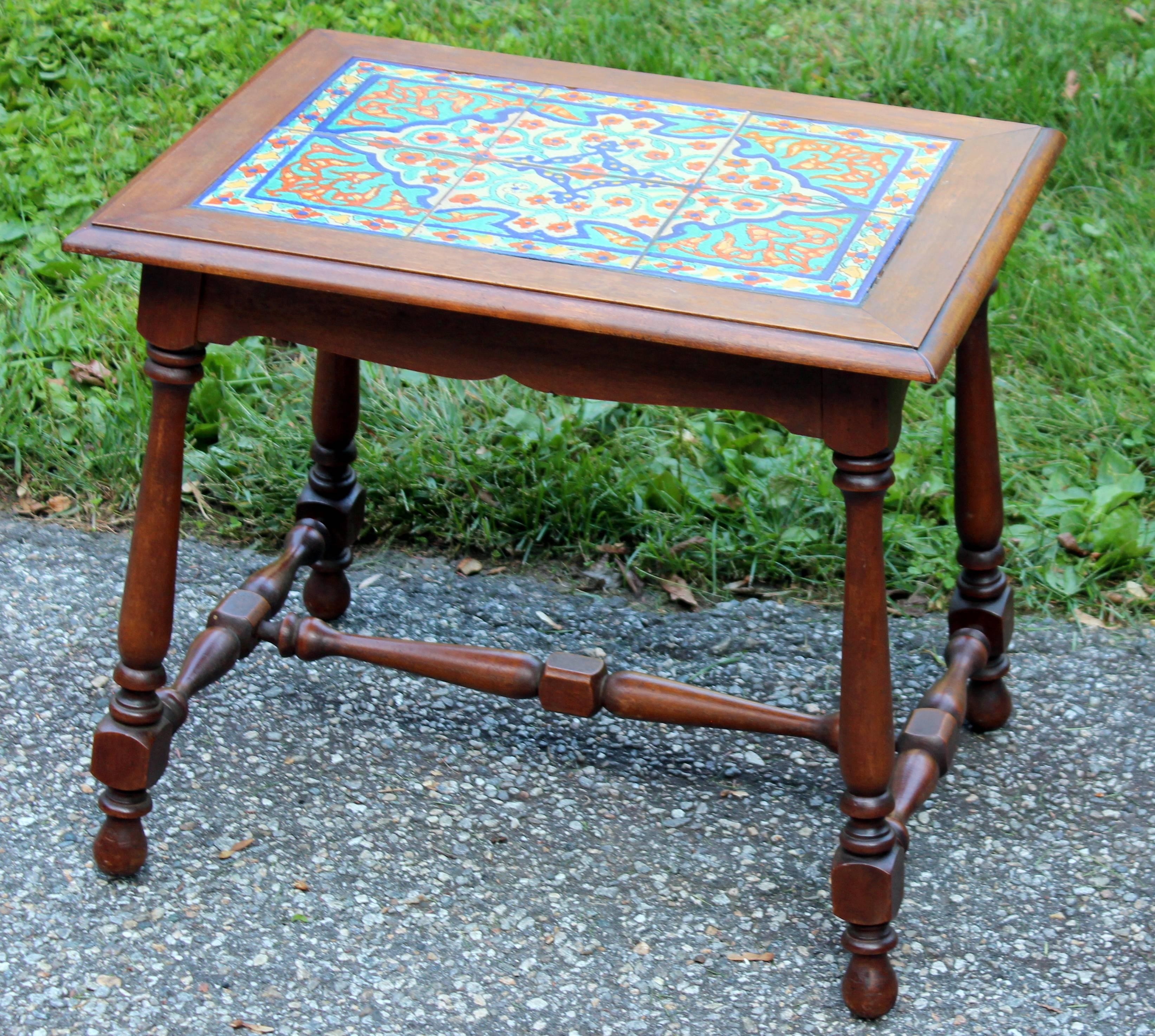 Antique California tile table with Hispano-Moresque style tiles in great blue, turquoise, red glazes, circa 1920s. Set in a beautiful walnut frame with fine turnings. Measure: Tiles are about 6