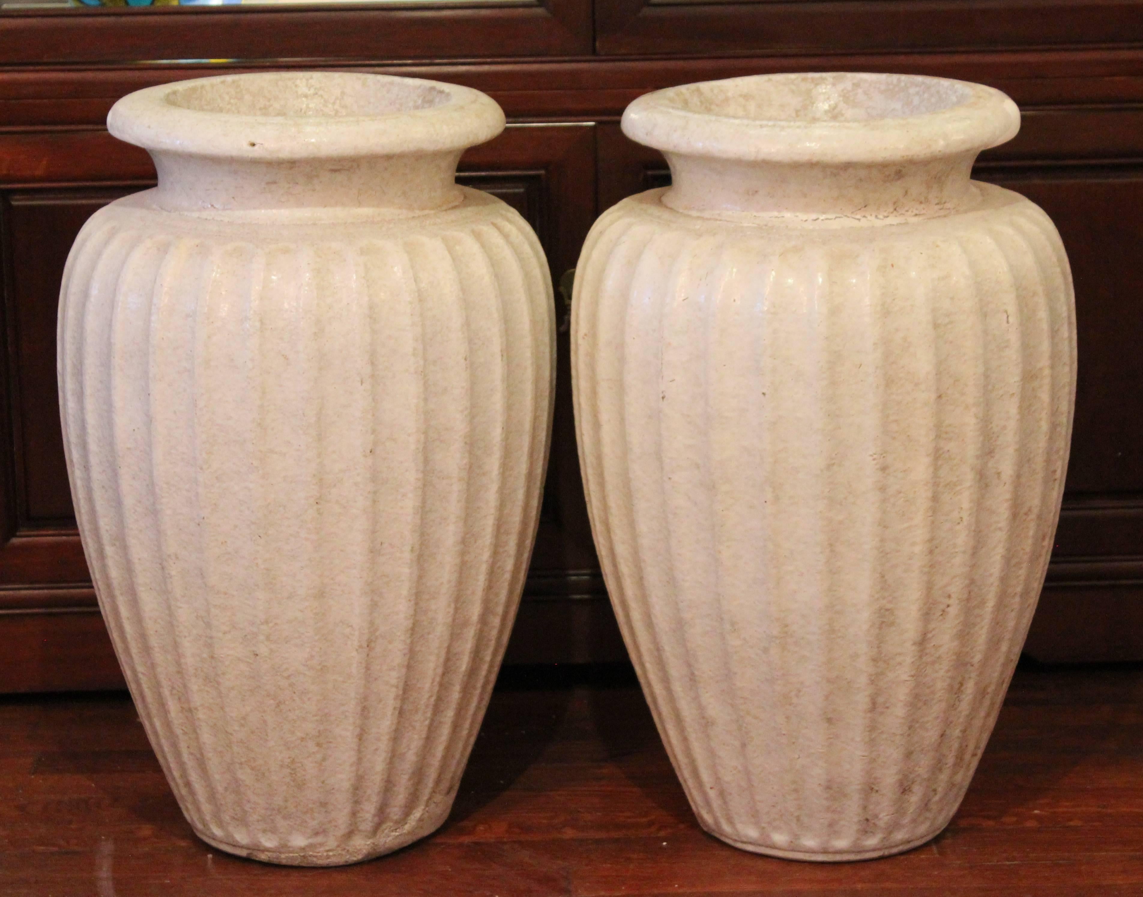 Large pair of fluted garden urns by the Galloway Terracotta Company of Philadelphia in classical form with great bone white wax matte glaze. Measures: 24
