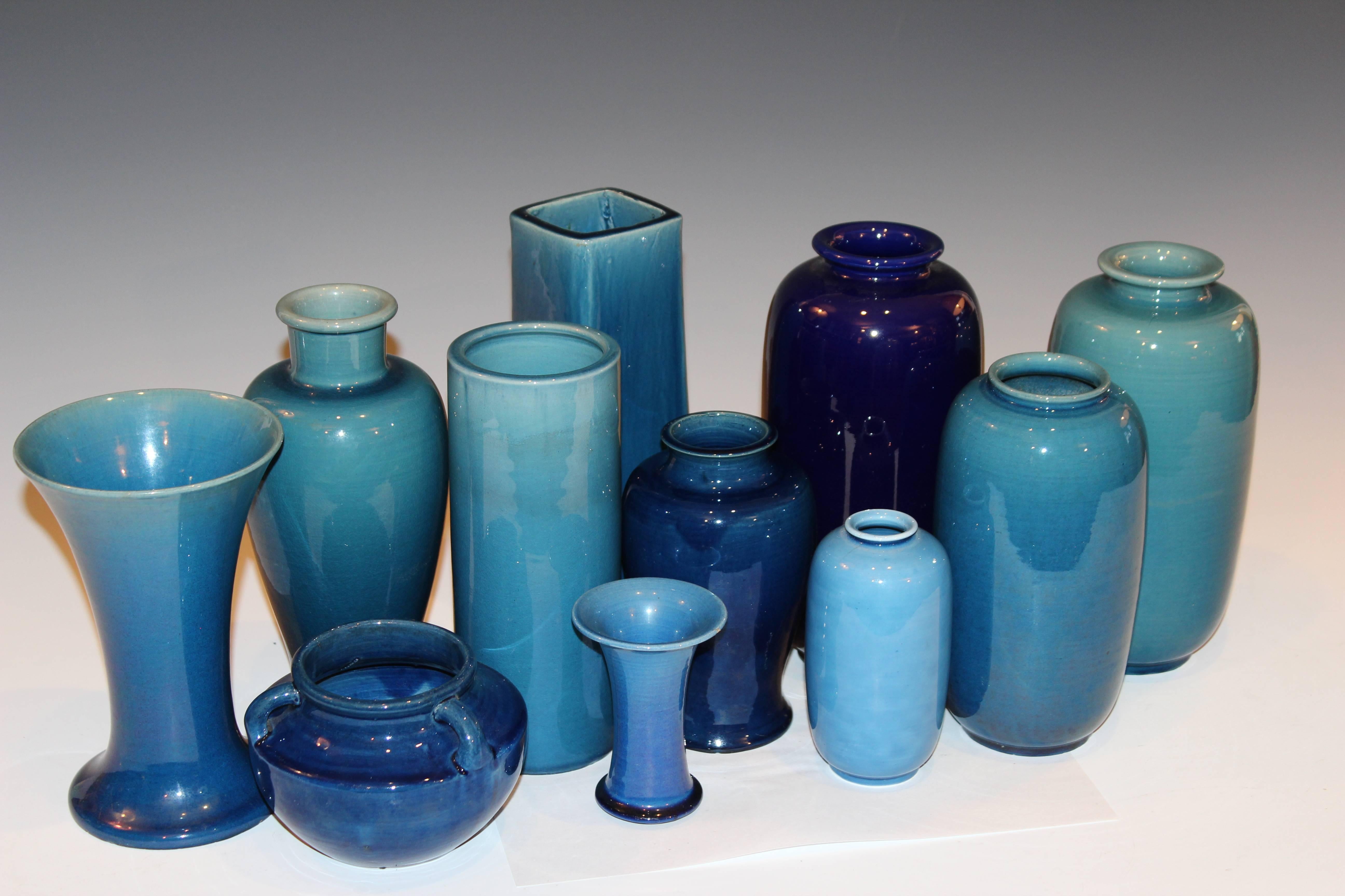 Nice collection of eleven hand-turned Awaji Pottery vessels in various tones of blue monochrome glaze, circa 1910s-1920s. Measures: 4 inches to 10 inches high. Some with impressed marks. Smallest jar with hairline and hole in base, one piece with