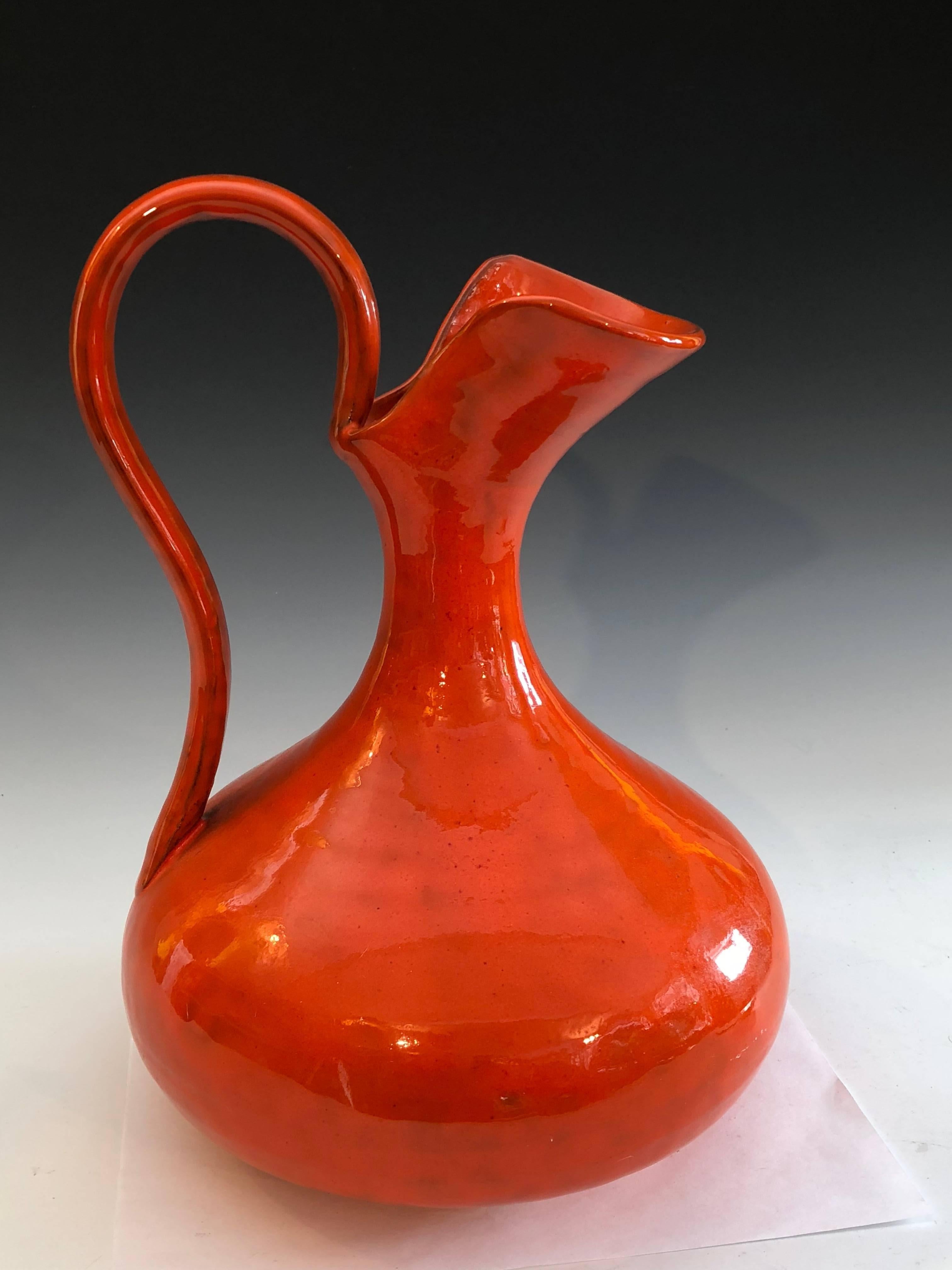 1960s hand-turned Italian pottery pitcher vase in classical form with electric mottled orange glaze. Attributed to Italica Ars. Measures: 13