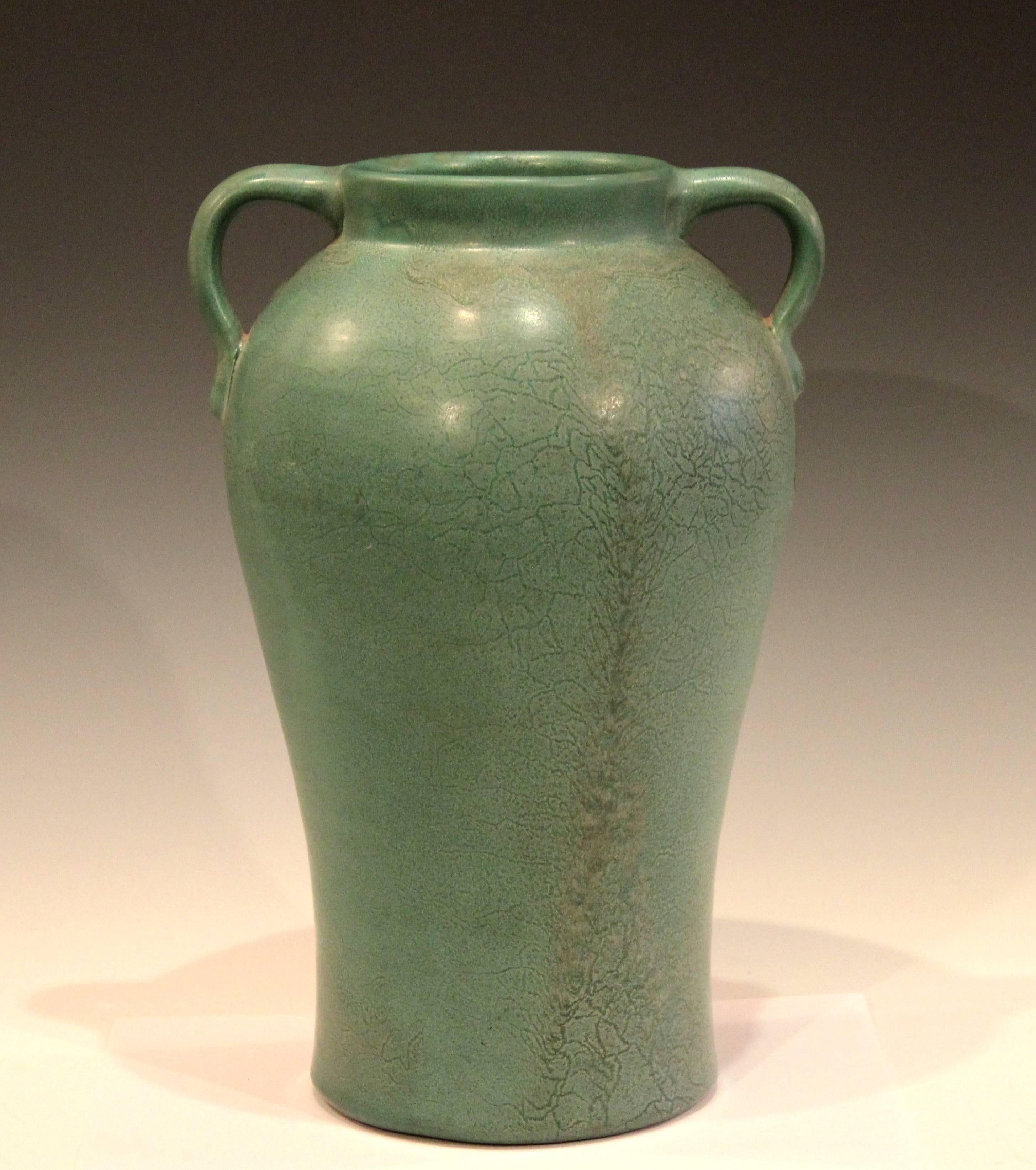 Hand turned Genuine Bybee (1922-1929) Kentucky art pottery vase in pleasing form with gentle swell to upper body, applied handles, and fantastic, curdled matt green glaze. 13