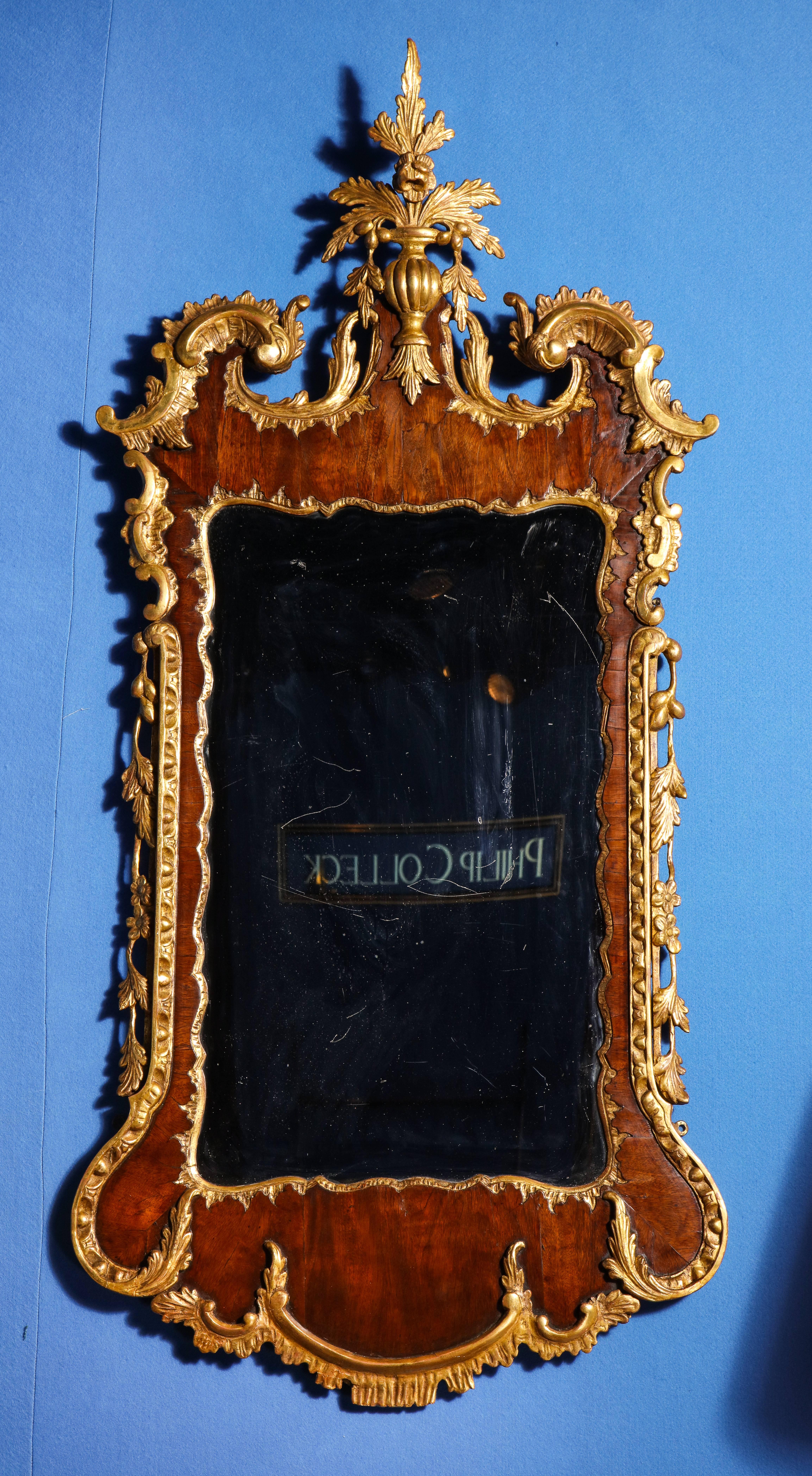A superb antique George II parcel-gilt mahogany mirror, having a wonderful leaf and rosette central cartouche above a swan's neck pediment with 