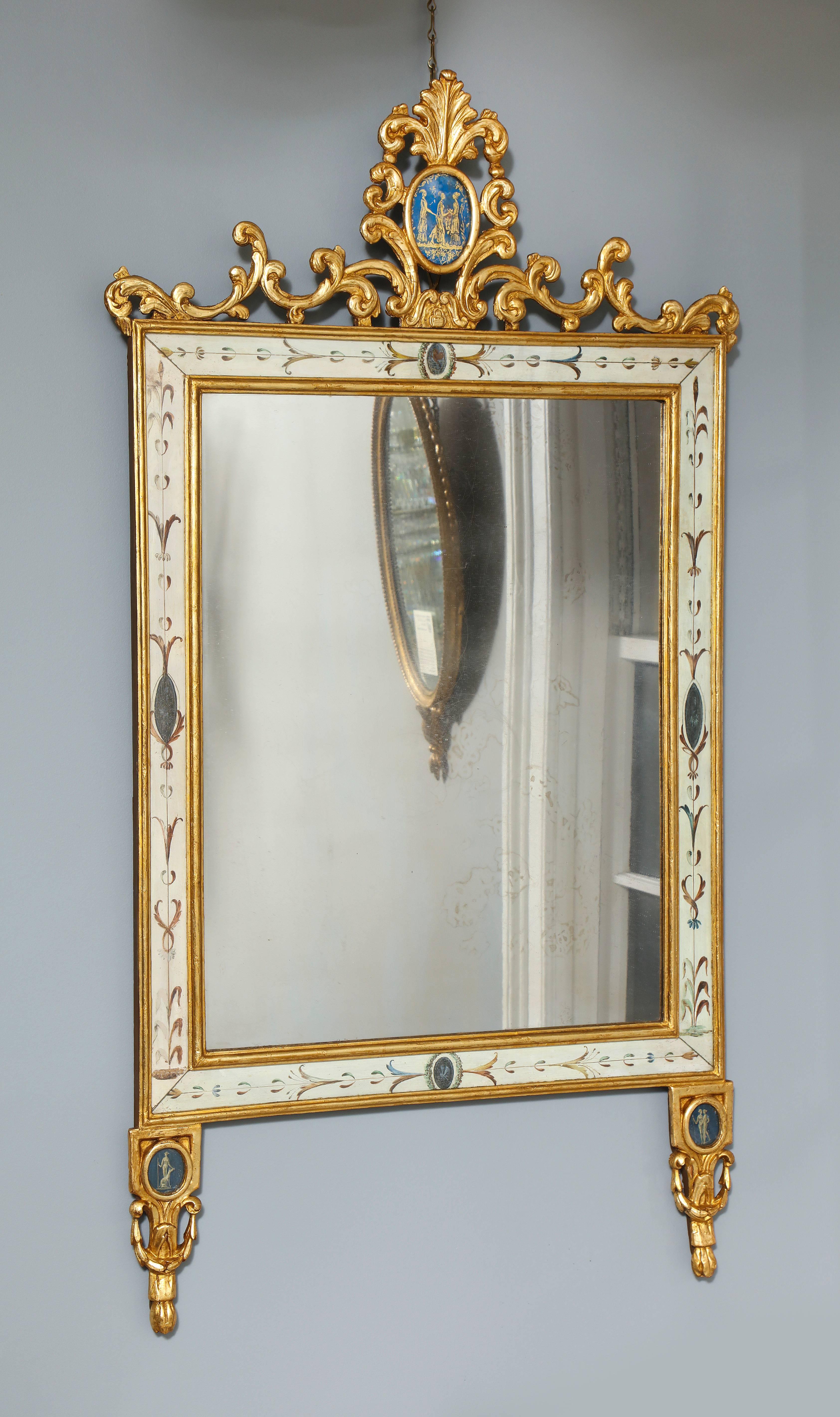 Fine Italian Neoclassical Painted and Parcel Giltwood Mirror, having a scrolling leaf carved and pierced gilt cresting with verre églomisé oval panel above a rectangular plate with a clear glass border surround, the frame painted in the “Pompeian”