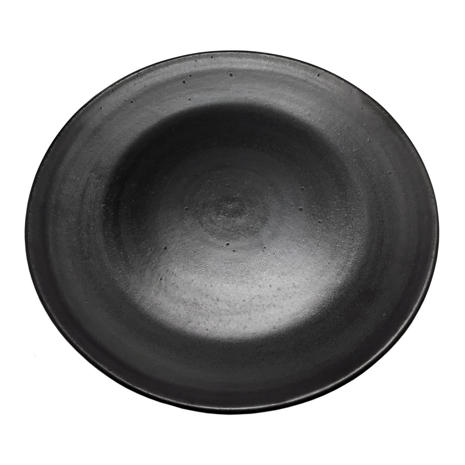 Black wax glaze ceramic round tray by Sandi Fellman, USA, 2016.

Veteran photographer Sandi Fellman's ceramic vessels are an exploration of a new medium. The forms, palettes, and sensuality of her photos can be found within each piece. The tactile