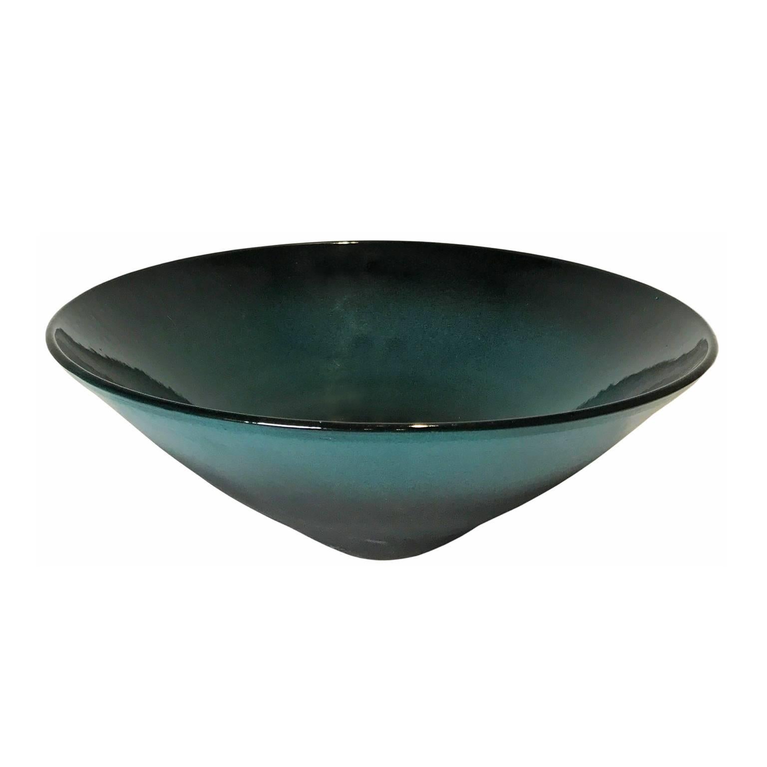 Matte black and turquoise ombre glaze point base ceramic bowl on  with glossy turquoise and black glaze interior by Sandi Fellman, USA, 2017.

Veteran photographer Sandi Fellman's ceramic vessels are an exploration of a new medium. The forms,