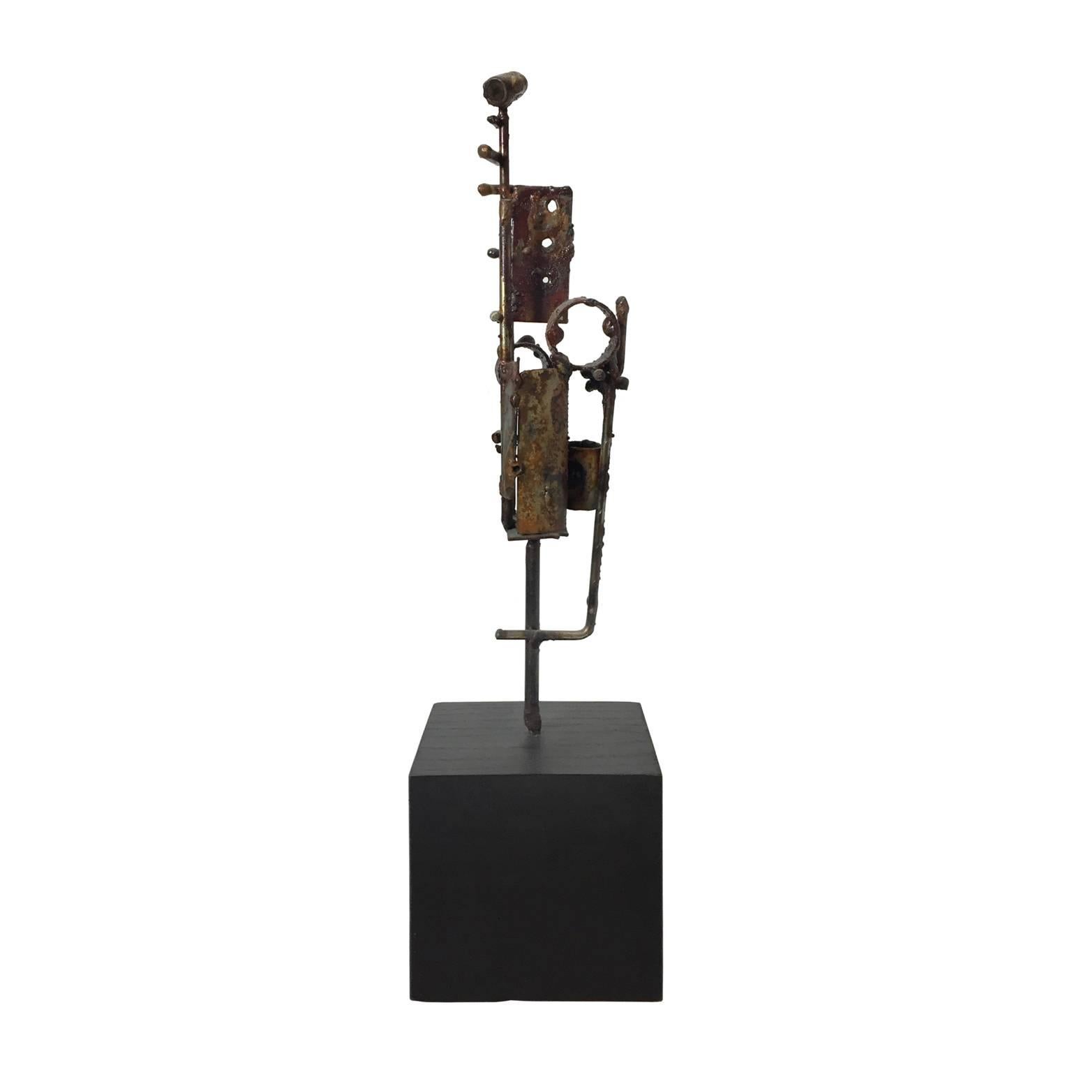 Brutalist welded metal sculpture on black wood base by R.E. Andermann. USA, 1972.