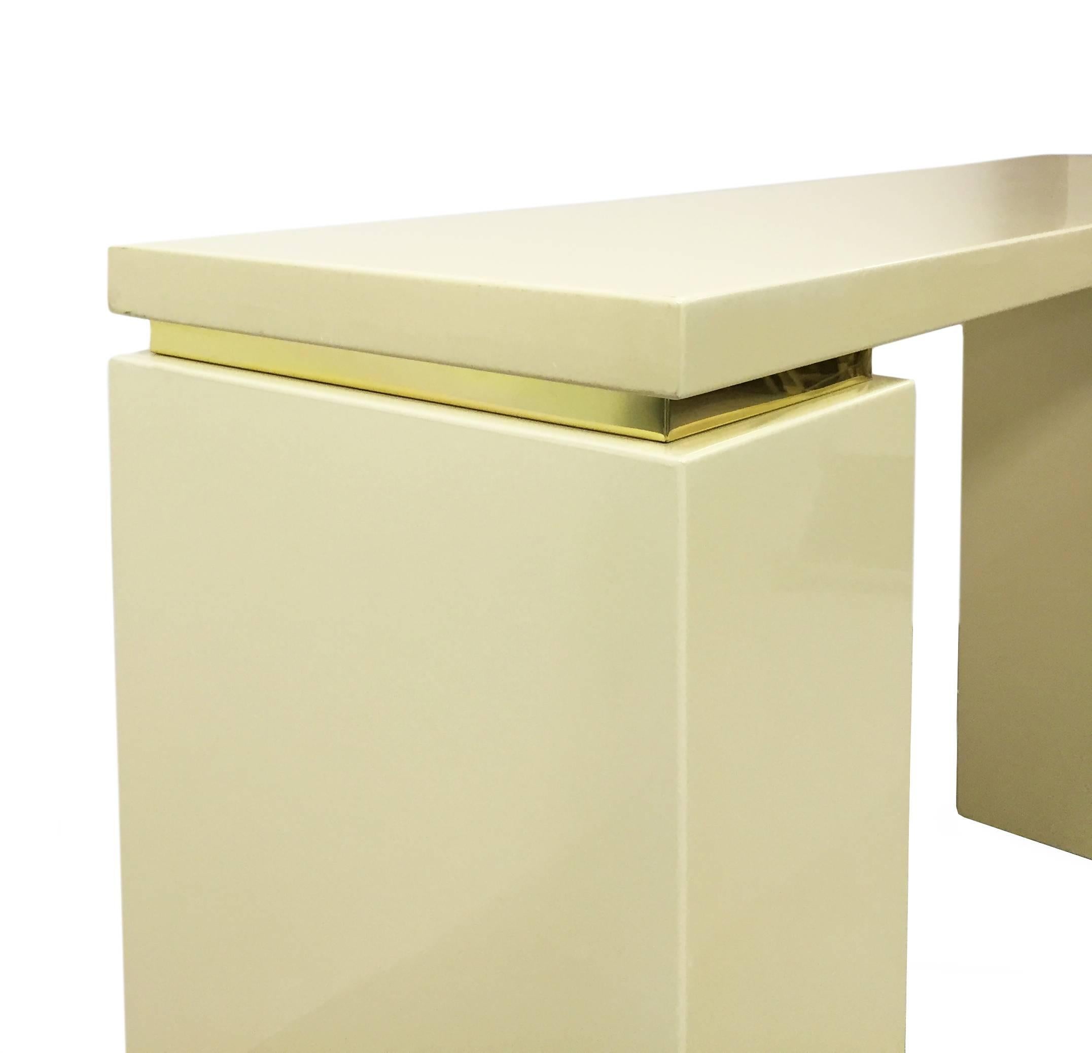 Ivory lacquer console with brass banding detail by Jean Claude Mahey - French, 1970's.