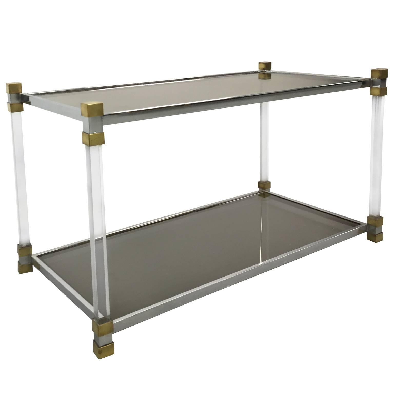 Chrome and Lucite two-tier side table with brass details and smoked glass top, French, 1970s.  
 