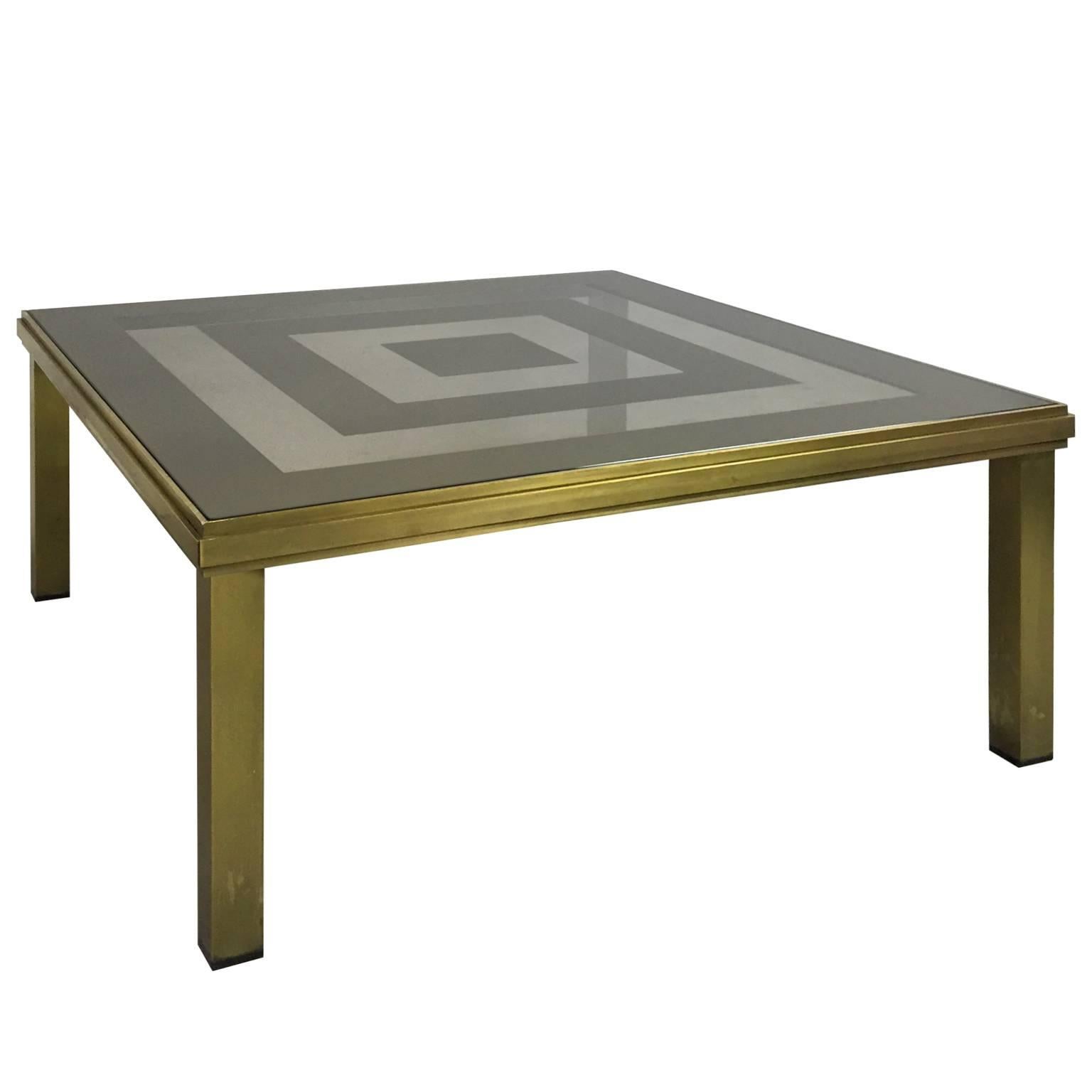 Square brass coffee table with concentric mirror top. French, 1970's. 