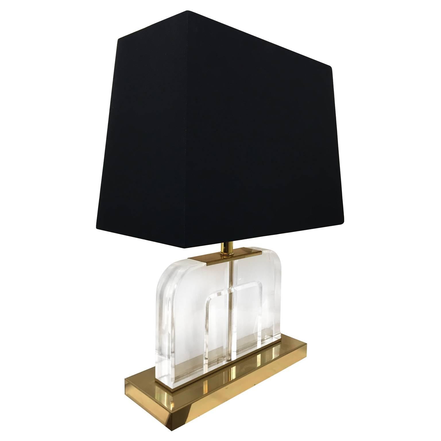 Vintage curved Lucite table lamps on brass base. 

Pair available, priced individually.