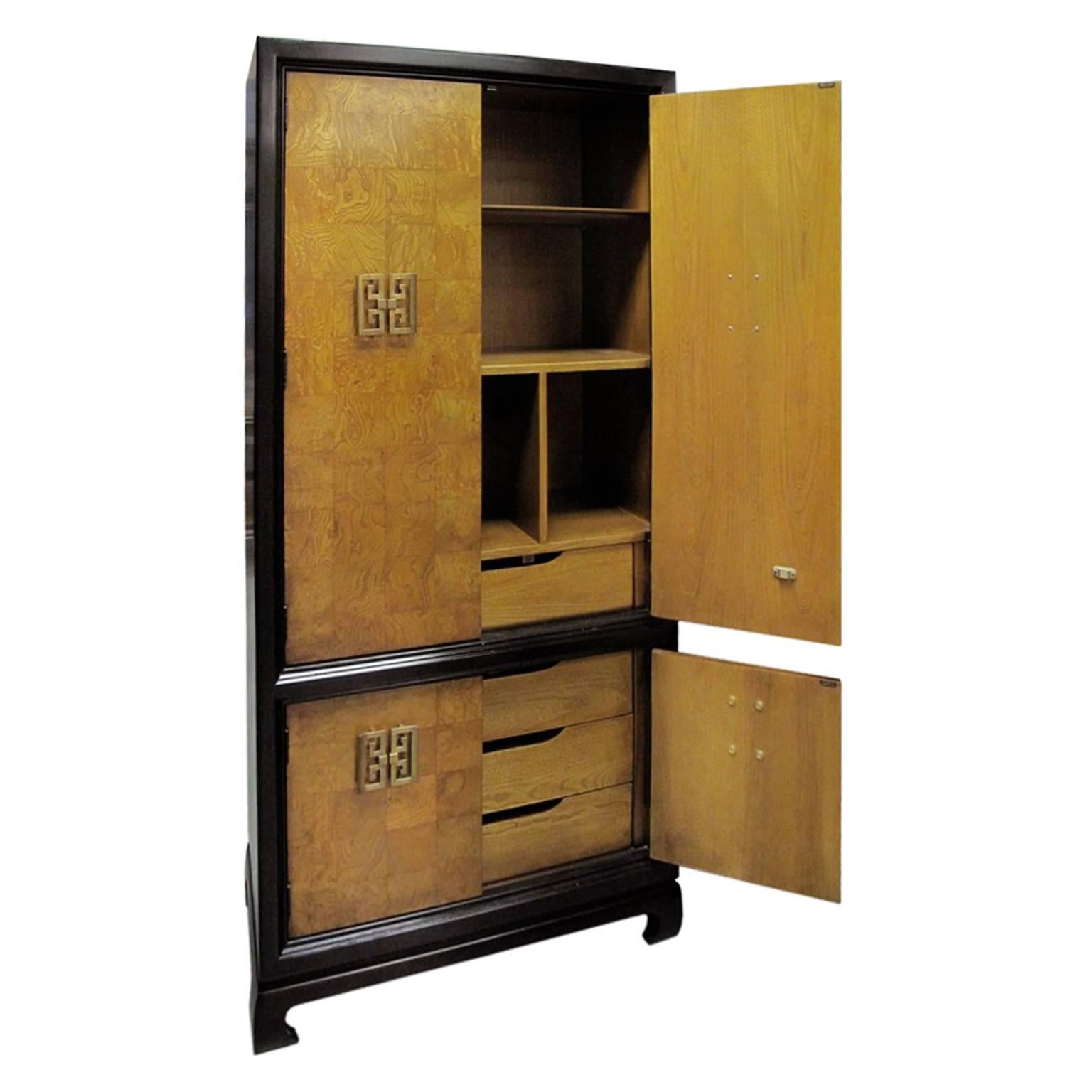 French tall chinoiserie style burl wood patchwork cabinet with Asian style brass pulls.

If you would like to see this piece in person, please contact us to schedule a viewing.
         