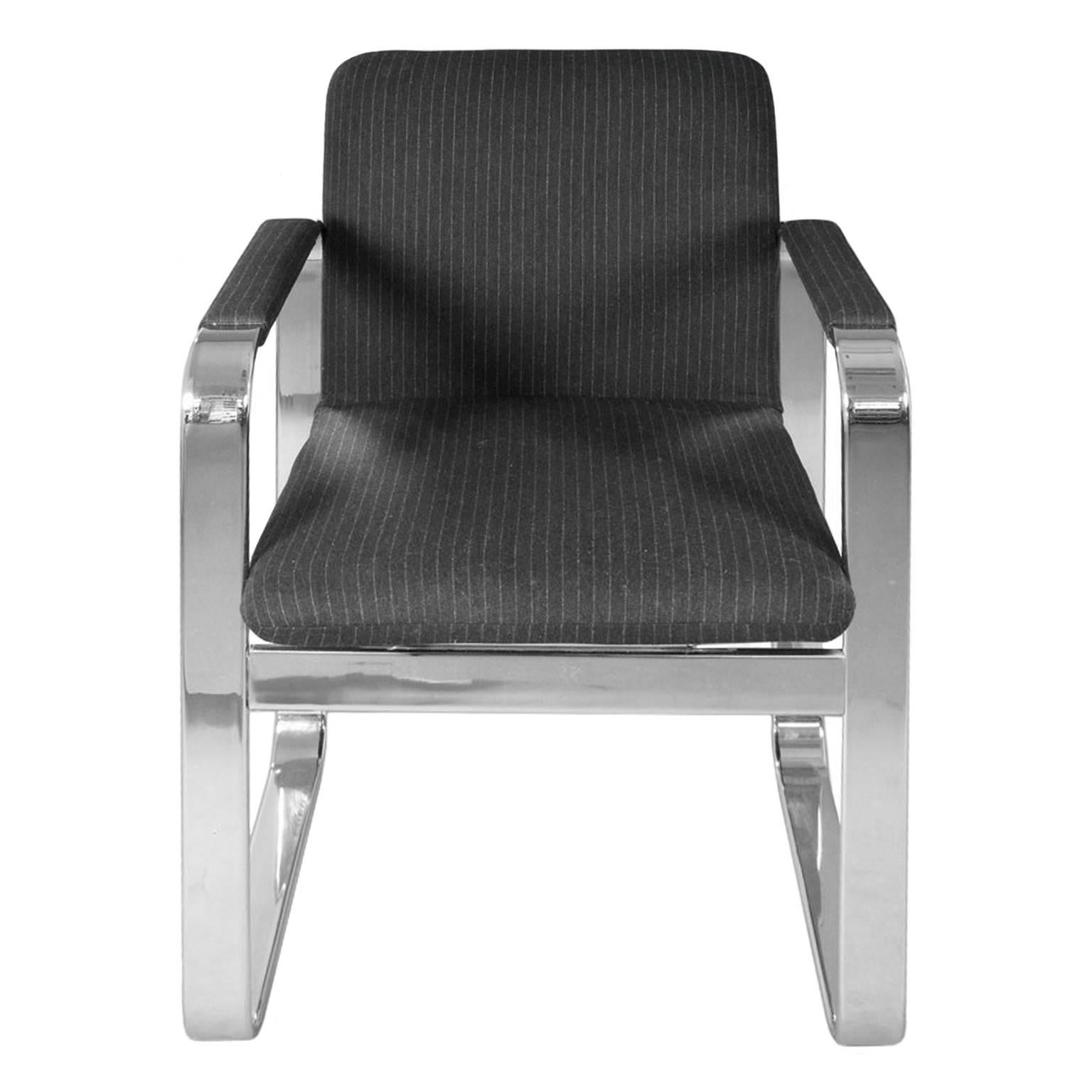 Chrome armchair with rounded rectangular frame, newly upholstered in a charcoal pinstripe wool. USA, 1970's.