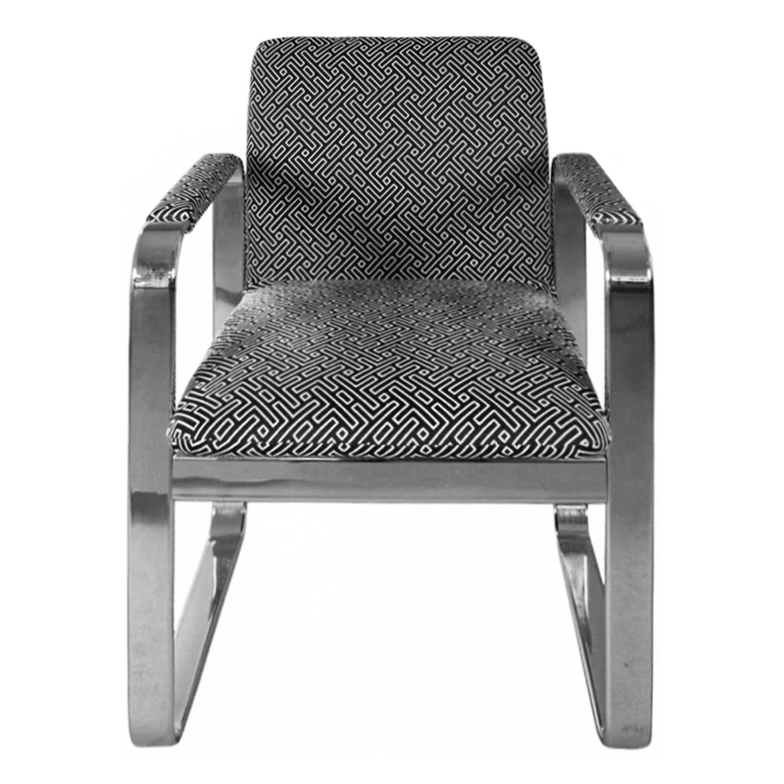 Chrome armchair with rounded rectangular frame, newly upholstered in a black and white geometric cotton. USA, 1970's. 


