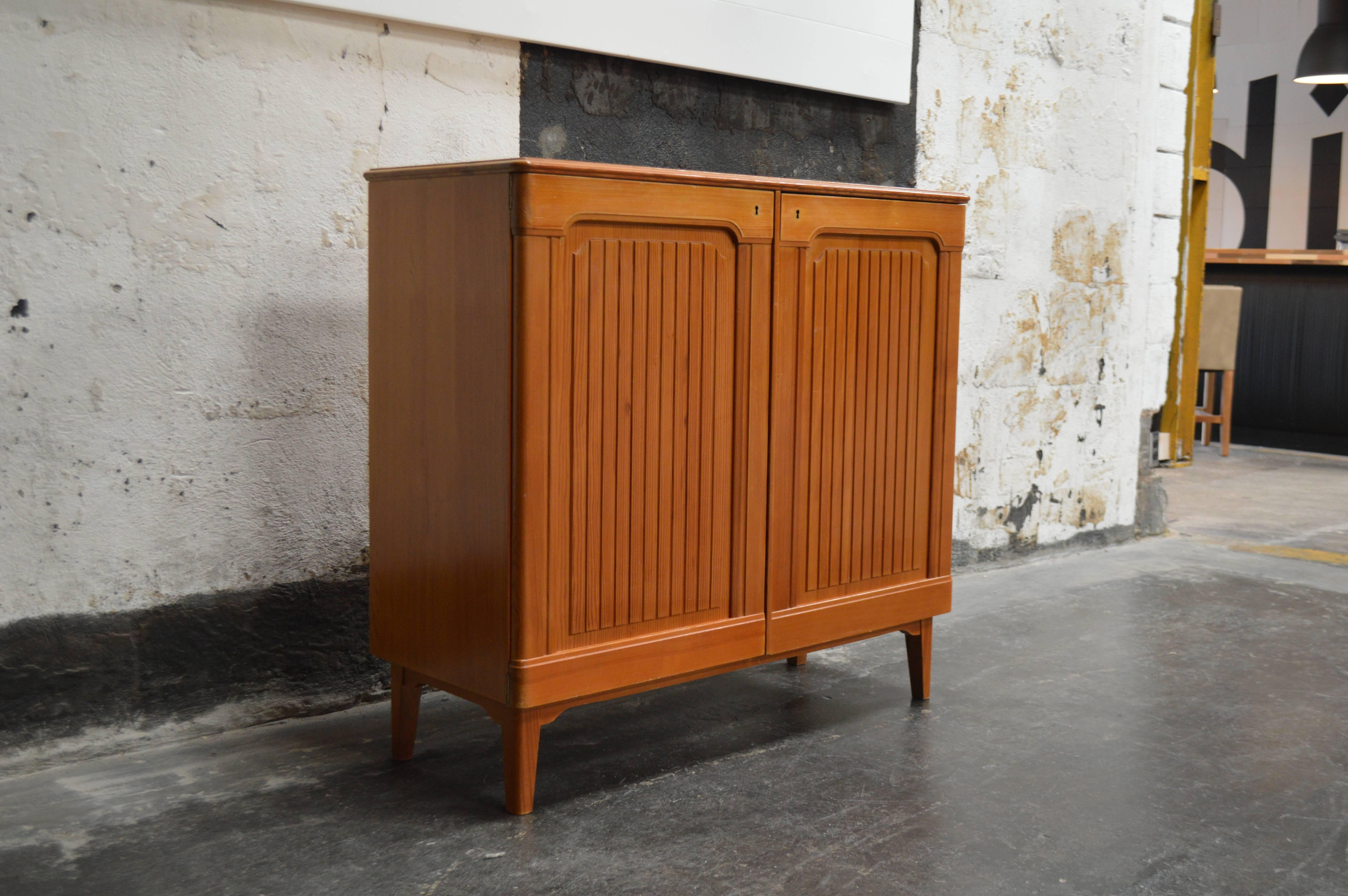 Mid-Century Svenska fur (Swedish Pine) storage cabinet by Carl Malmsten. Fluted doors open to reveal shelves and drawers. All shelves and drawers are adjustable to configure however you like. Excellent vintage condition. Key included.