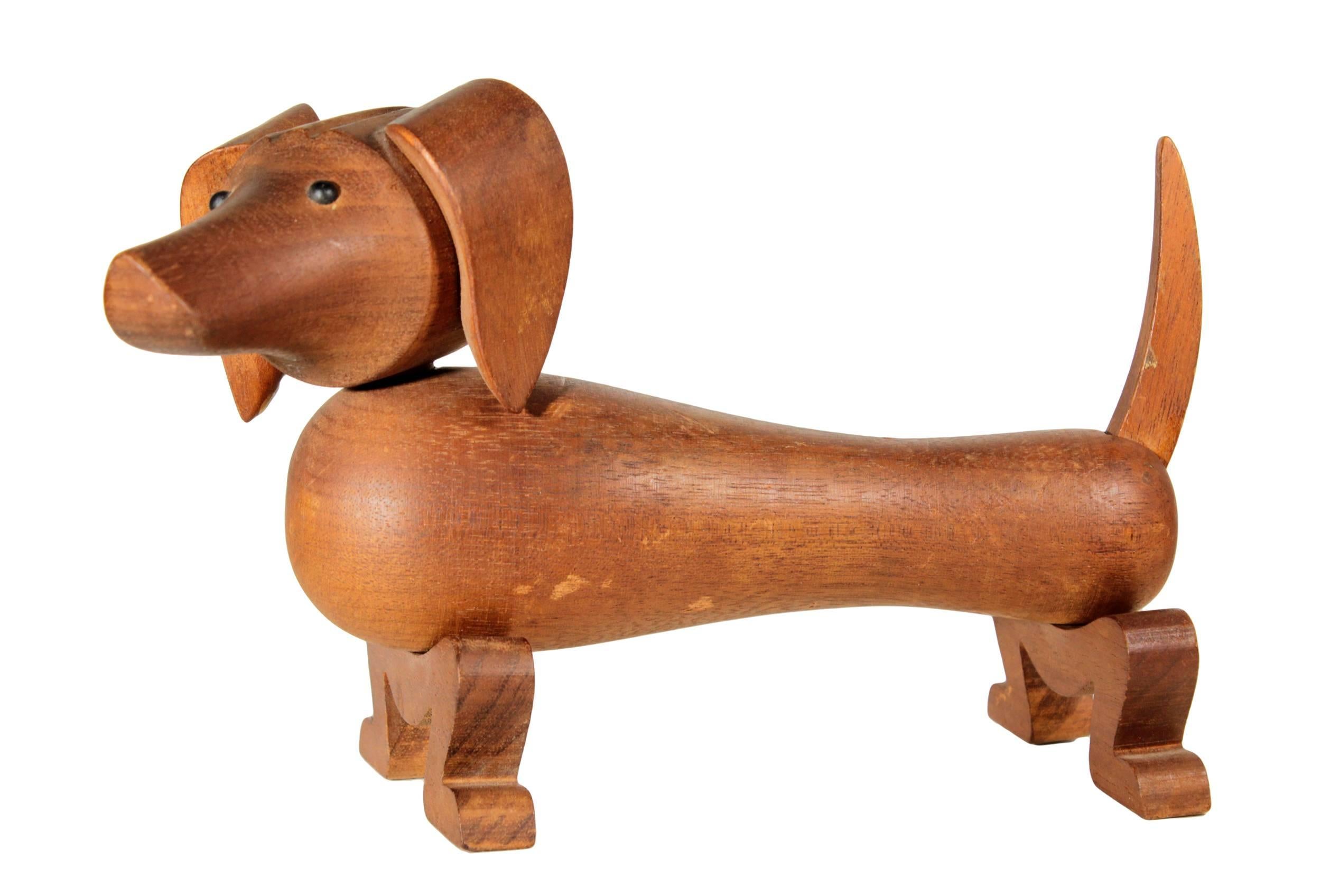 An icon of modern Danish design, Bojesen achieved worldwide acclaim for his collection of wooden toys.This mahogany dachshund was first produced in 1934 and was his first articulated toy and the first of several dog figures. It has scattered