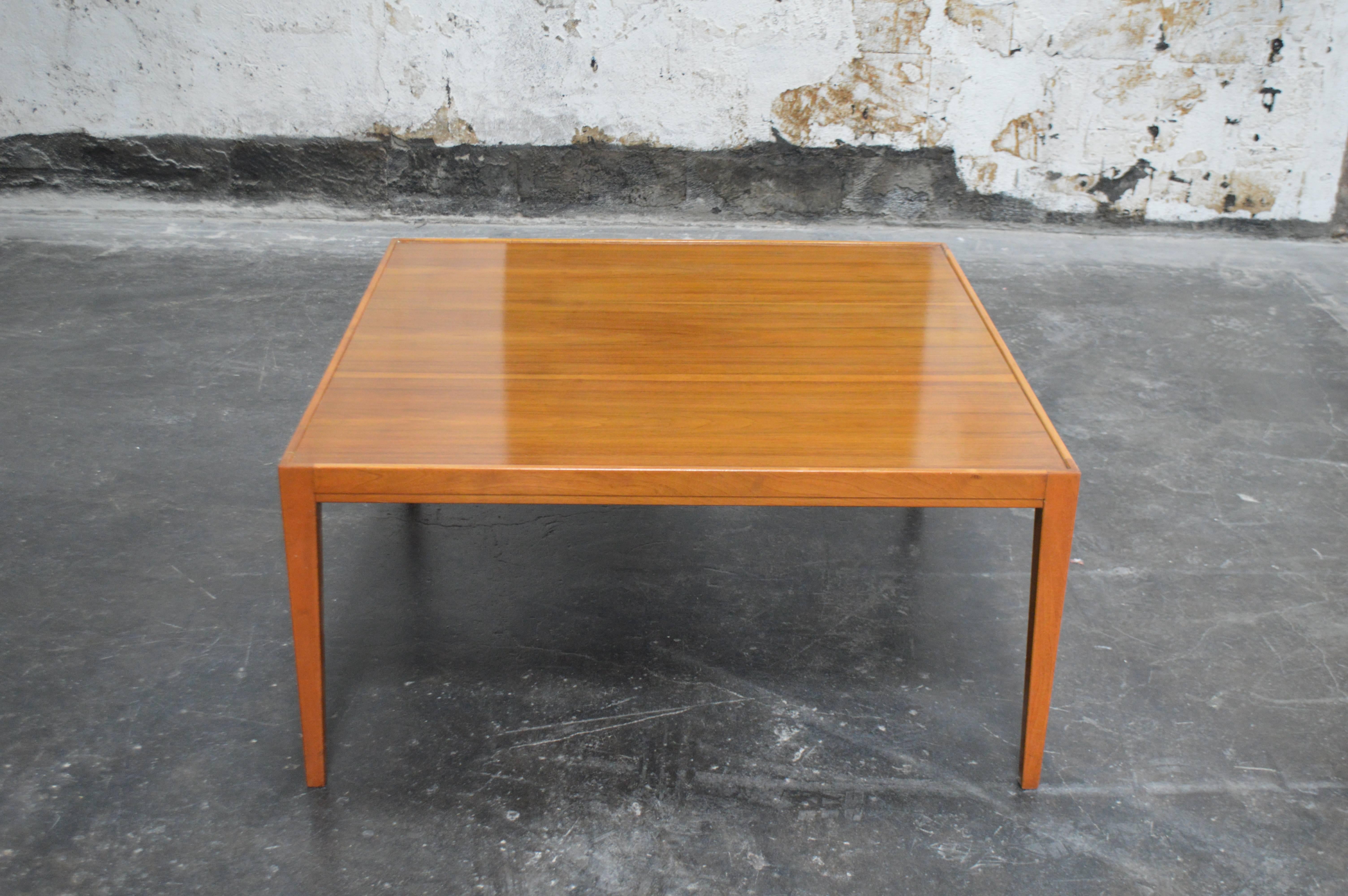 Sleek modern square coffee table with beautiful wood grain and atop tapered legs. Nice large size of 41.25