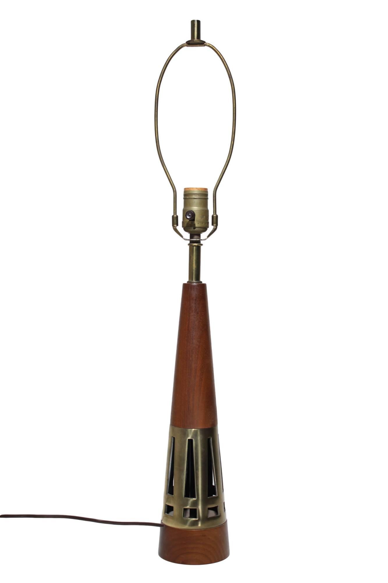 A Mid-Century Modern conical lamp by Tony Paul for Westwood. Finely turned slim walnut cone with an inlaid cast brass section. A few very light scratches to wood and a bit of patina to upper brass parts. In very good working condition, with a