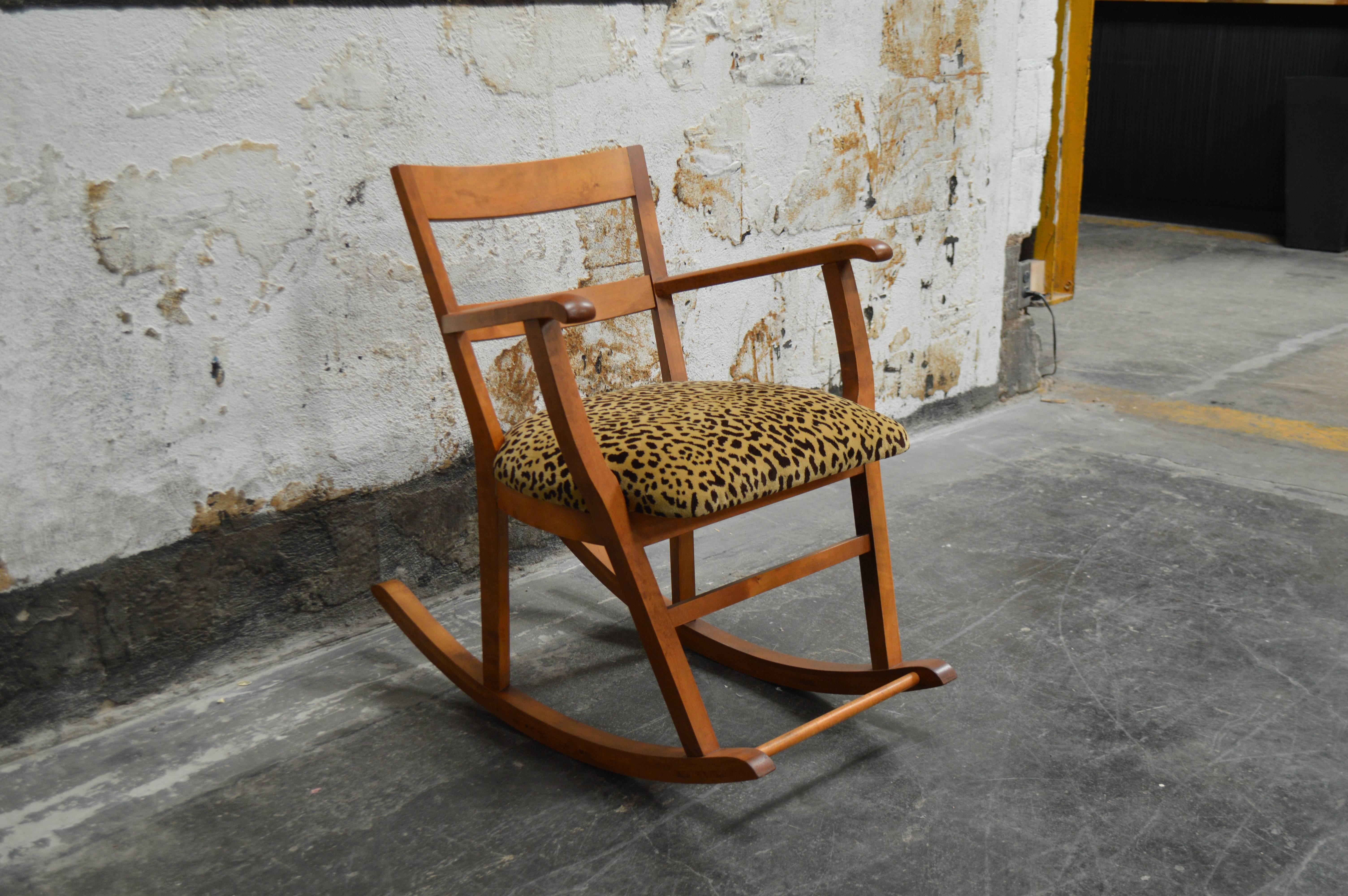 Comfortable rocking chair featuring newly upholstered seat in a leopard mohair velvet. Crafted of golden elm the original finish has been touched up and restored to retain the mellowed golden color. 

Dimensions: 
24.5