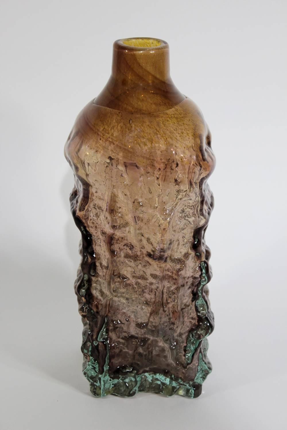 A large, heavy bark-textured bottle vase in cased glass designed by the innovative British industrial glass designer Michael Harris for Mdina Glass. Harris founded the company on the island of Malta in 1967 and was its principal designer until he