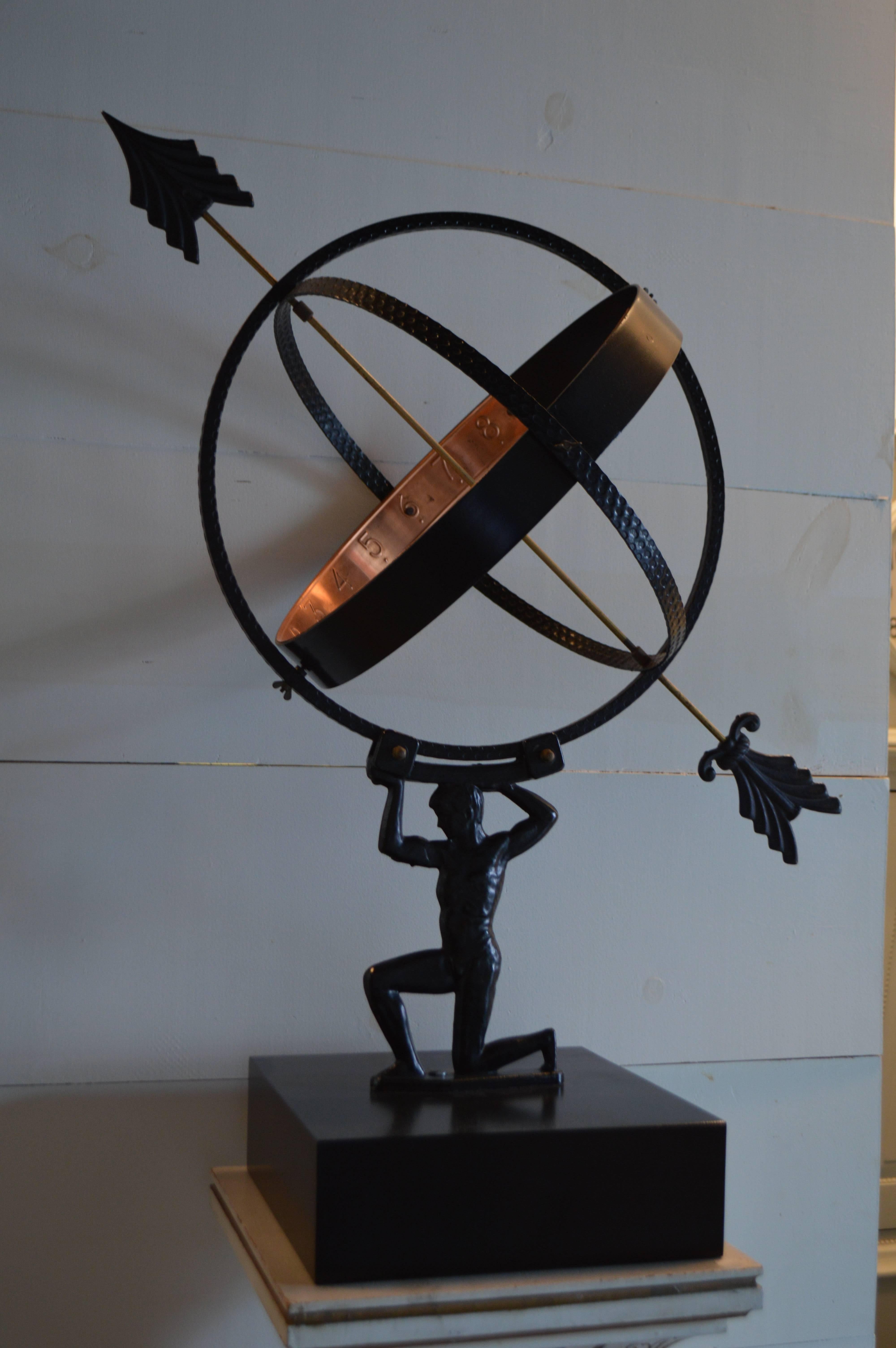 This figural armillary of Atlas, constructed of metal with a copper numeric banding, hails from Sweden. Original matte black finish and mounted on a well-proportioned custom wooden pedestal also painted in black lacquer. It is missing one strip of
