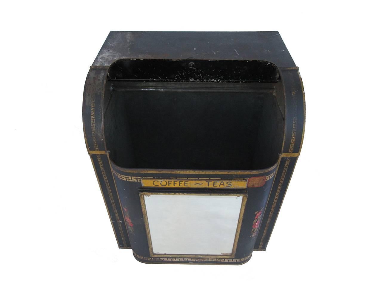 Turn of the century tin 'Coffee and Teas' bin with retractable lid, insert mirror on the front, black painted surface with gold gilt filagree decoration, all in as found surface and condition