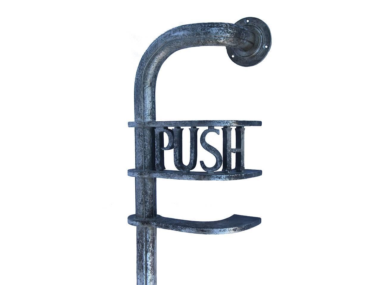 Unusual large-scale aluminum door handle with cut-out lettering 'Push', more than likely used in a commercial setting, as found surface, circa 1930.