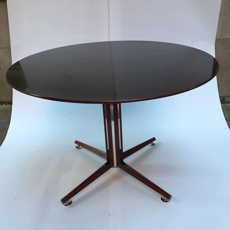 An Edward Wormley for Dunbar, dark walnut, black lacquered and polished white metal Inlaid pedestal table, circa 1950s, with a black lacquered top, chamfered walnut banding raised on an octagonal pedestal with polished white metal bands, four