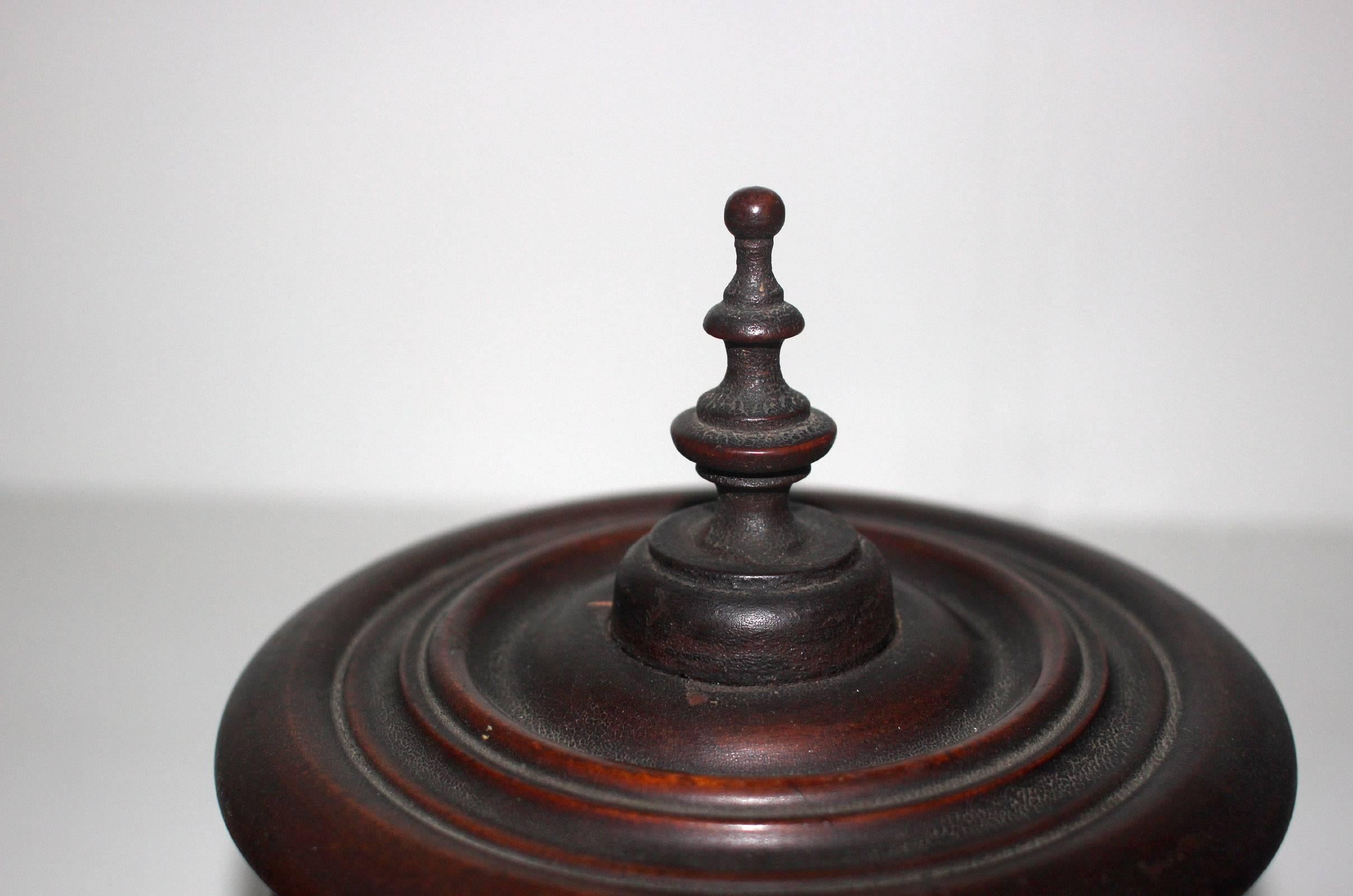 Skill in the needle arts was highly important for the great majority of women in the 19th century. Tools and objects that supported their craft held significance as well. This fine, turned mahogany spool holder contains spindles for ten spools, with
