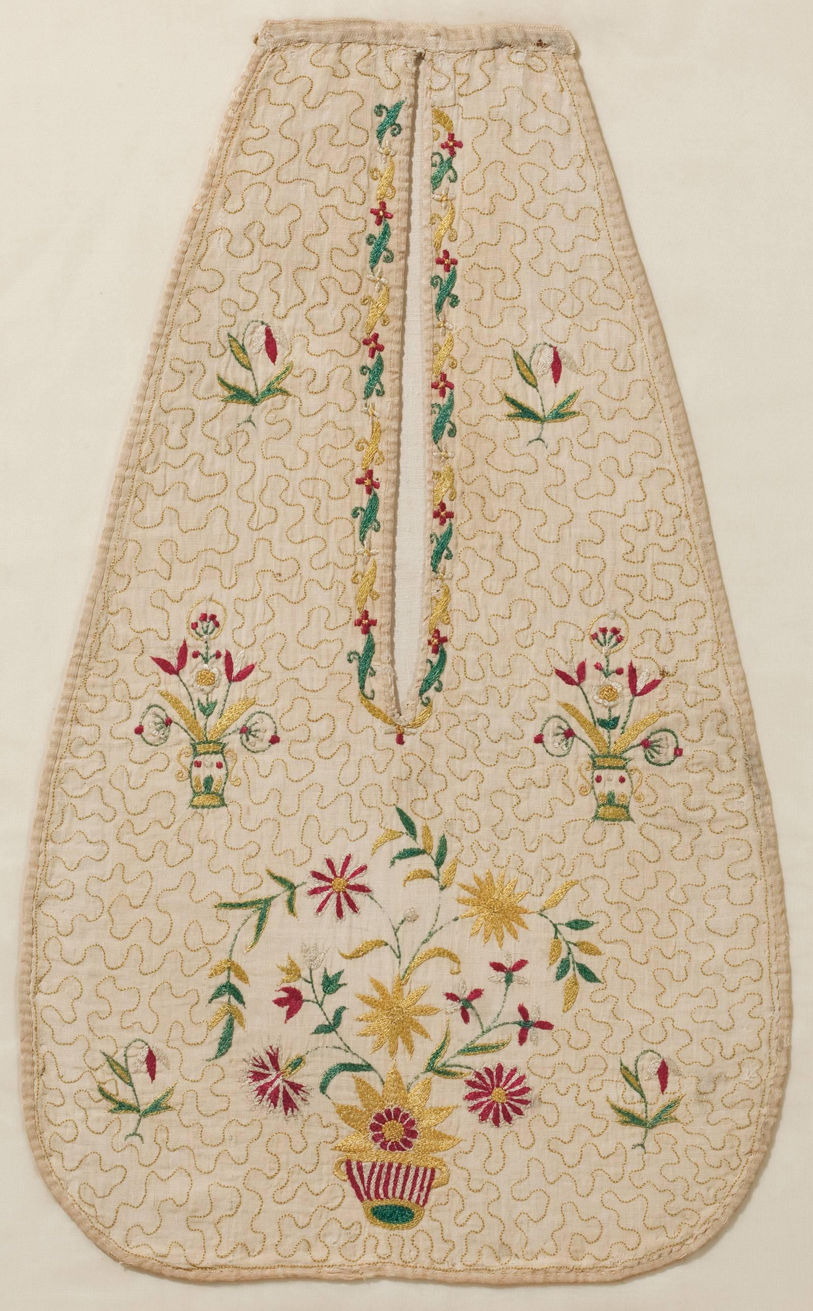 This beautifully embroidered English pocket would have been functional as well as decorative, and was likely worked by its owner. The polychrome needlework features a striped, two-handled basket filled with large blossom flowers on delicate, leafy