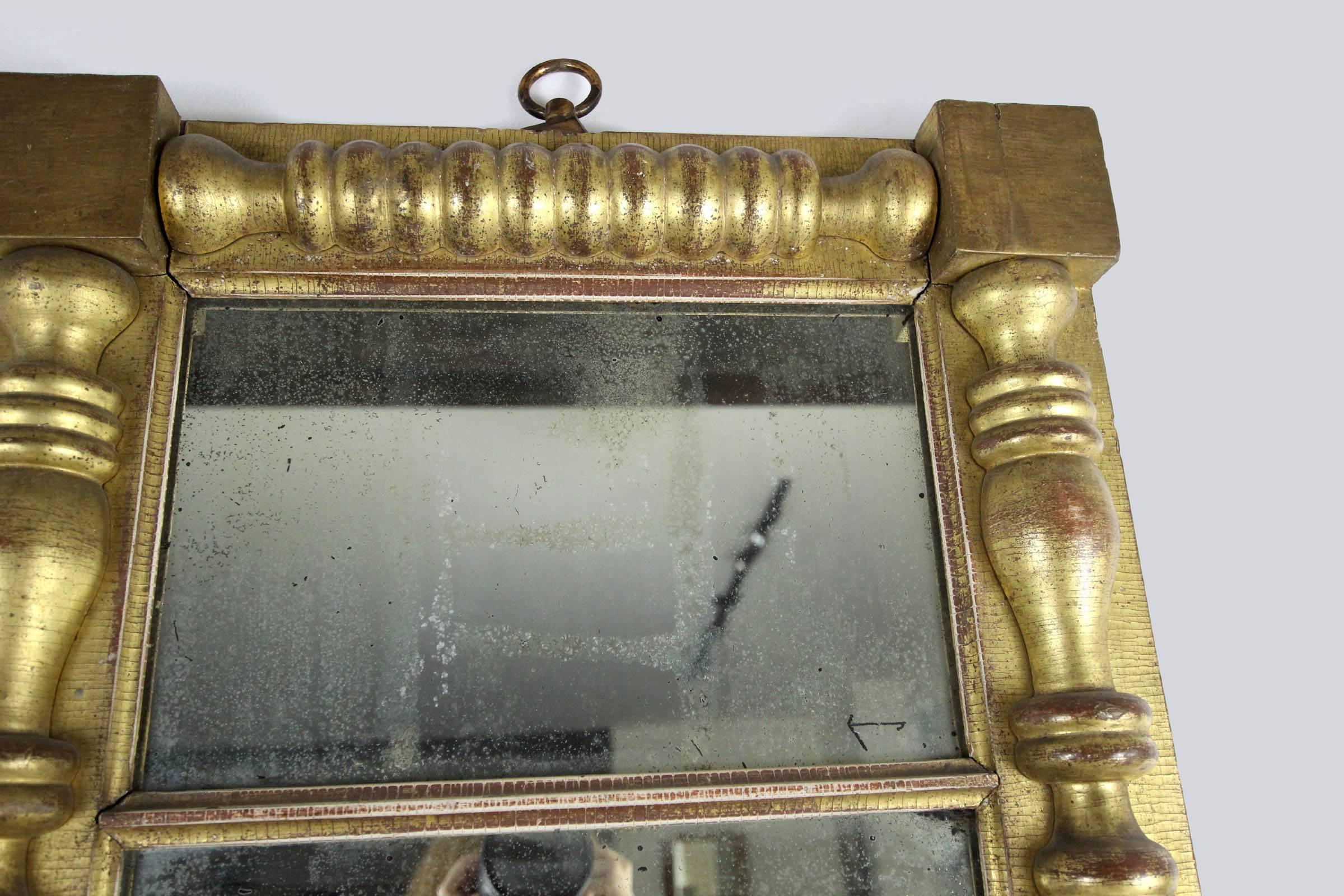 Large, excellent looking glass in heavy, gold leaf half-spindle and corner block frame, original mirror. Very good strong lines. Mirror is wonderfully crazed but still highly reflective, Philadelphia, circa 1825.