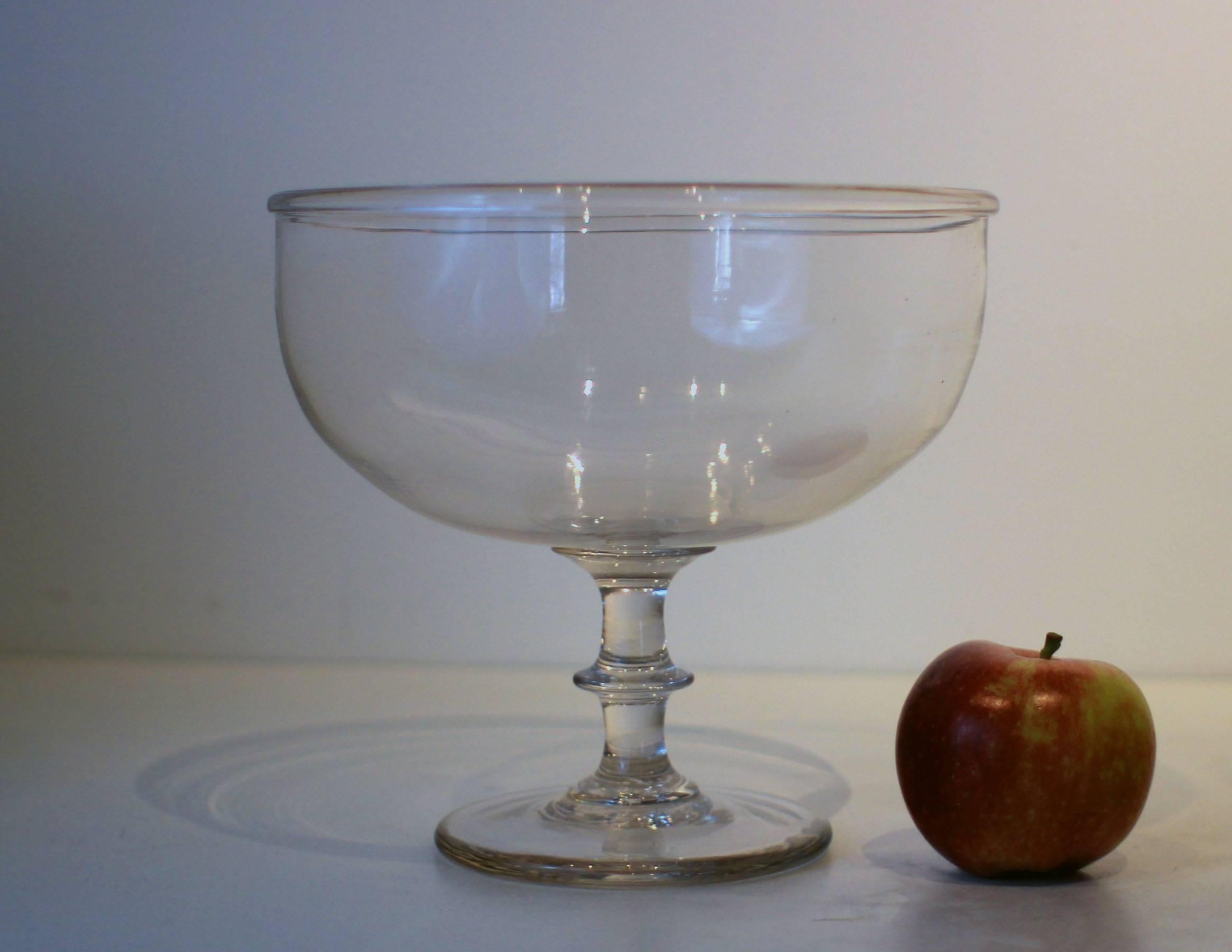 Very fine blown glass compote with a deep bowl and an applied base and rolled rim, from the early 19th century, New England, probably Massachusetts. Very good lines, crisp detail, excellent condition.