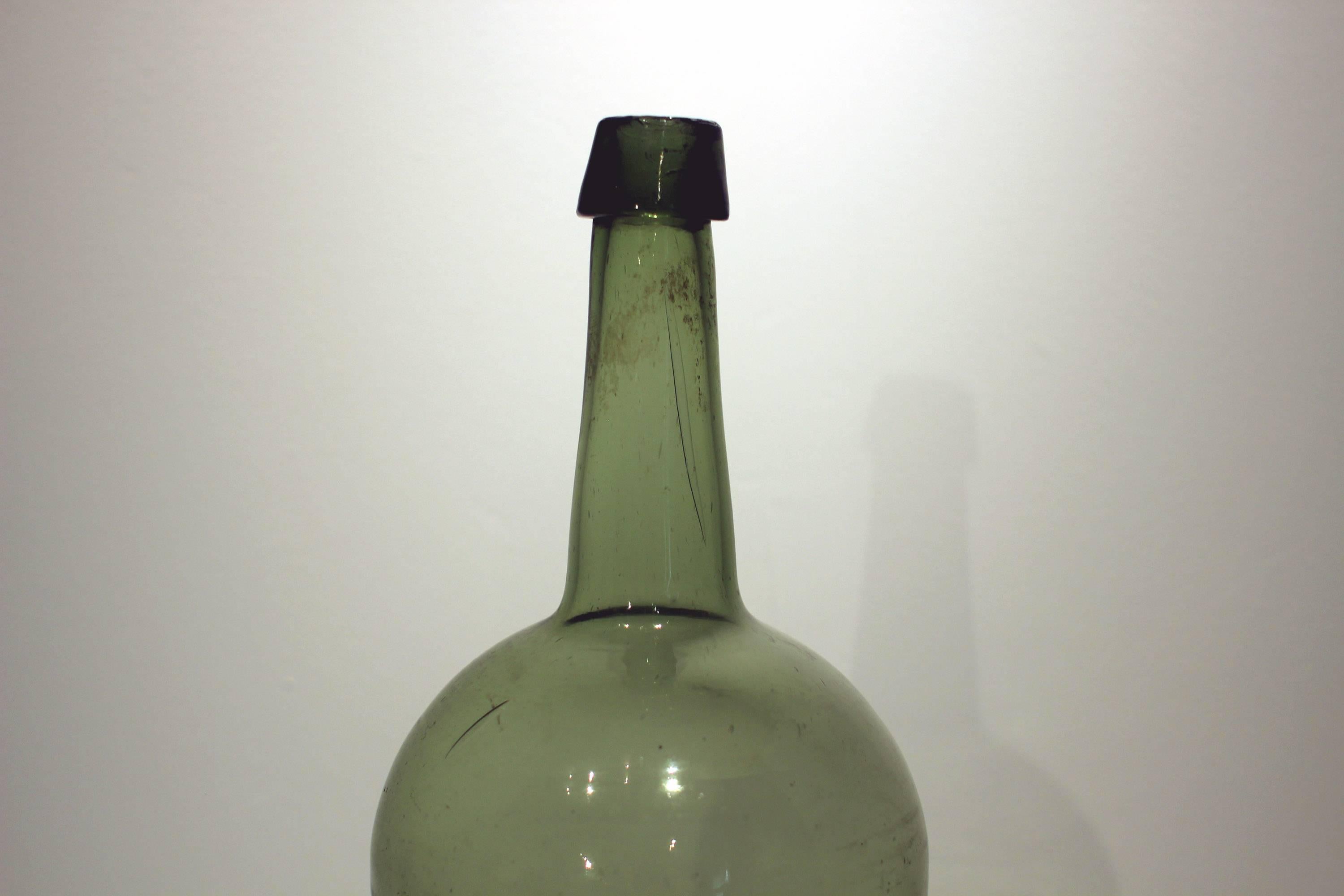 Olive yellow-green glass bottle, handblown and molded, with a nice long neck; American, third quarter of the 19th century. Very good form, excellent condition.