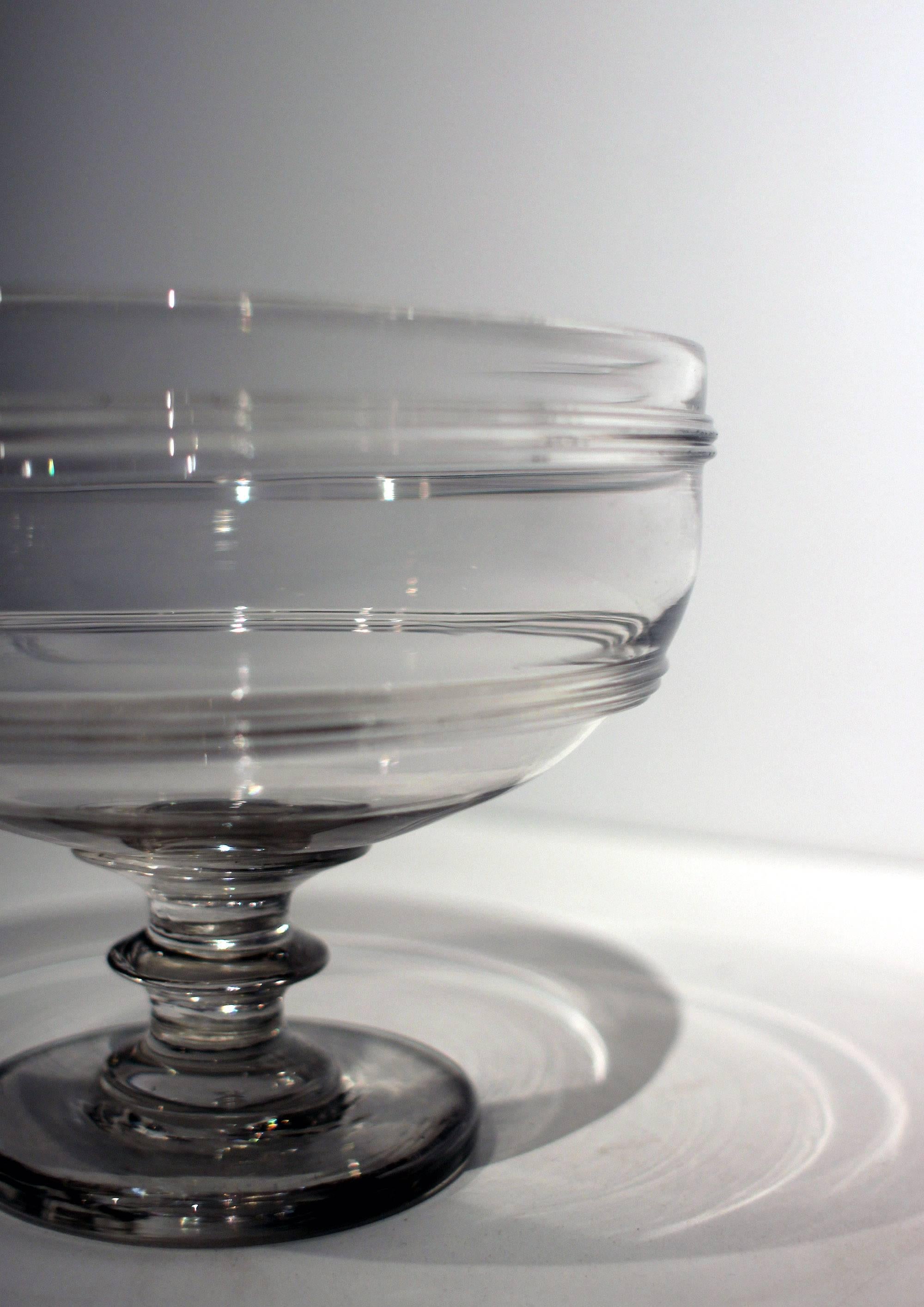 Fine blown glass compote on the heartier side with a deep bowl and unusual ringed detail and an applied base, circa 1830, New England, probably Massachusetts. Very good lines, crisp detail, excellent condition.
