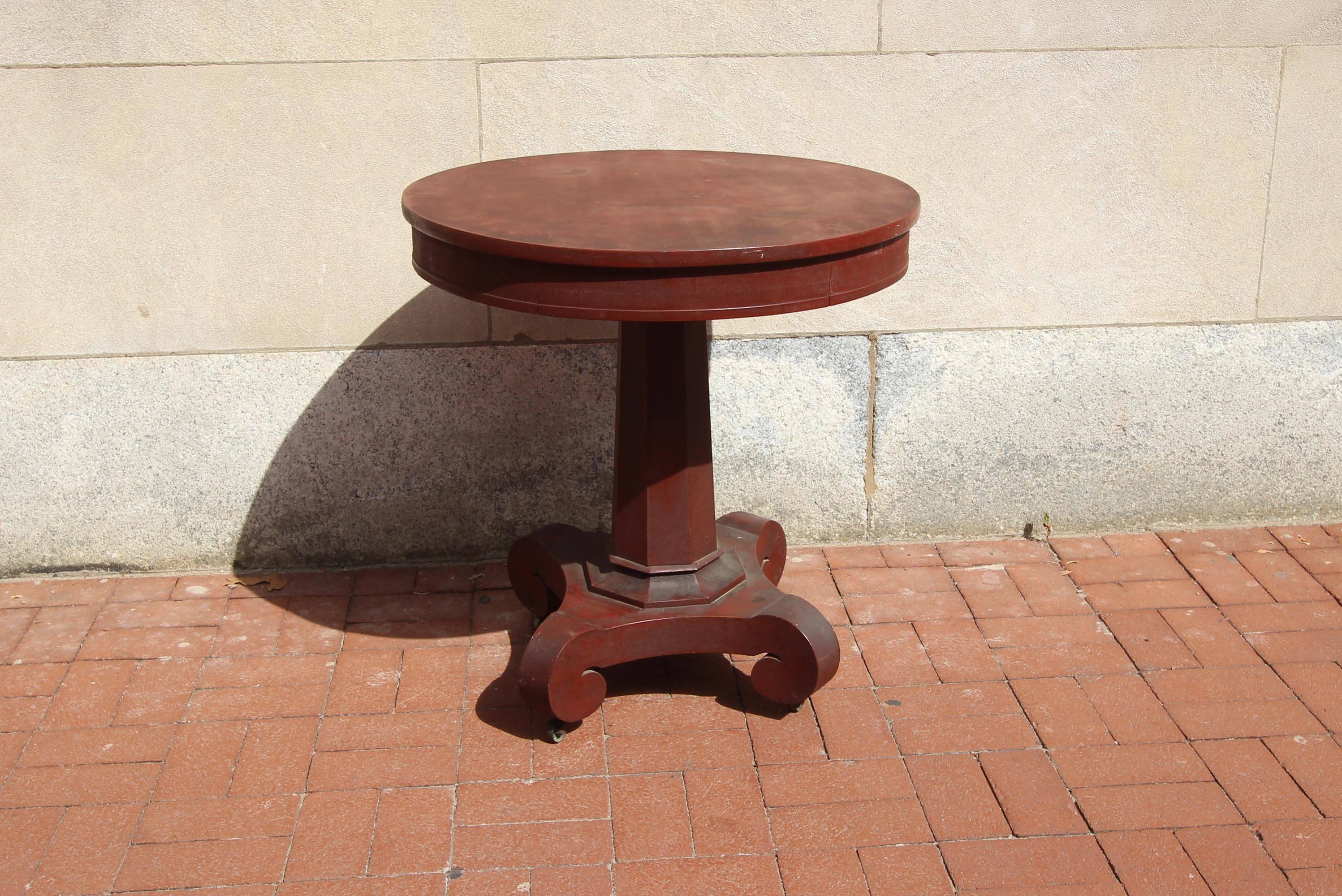 Great-looking center table with a dovetailed drawer, column base, original red paint and casters; American, circa 1840.