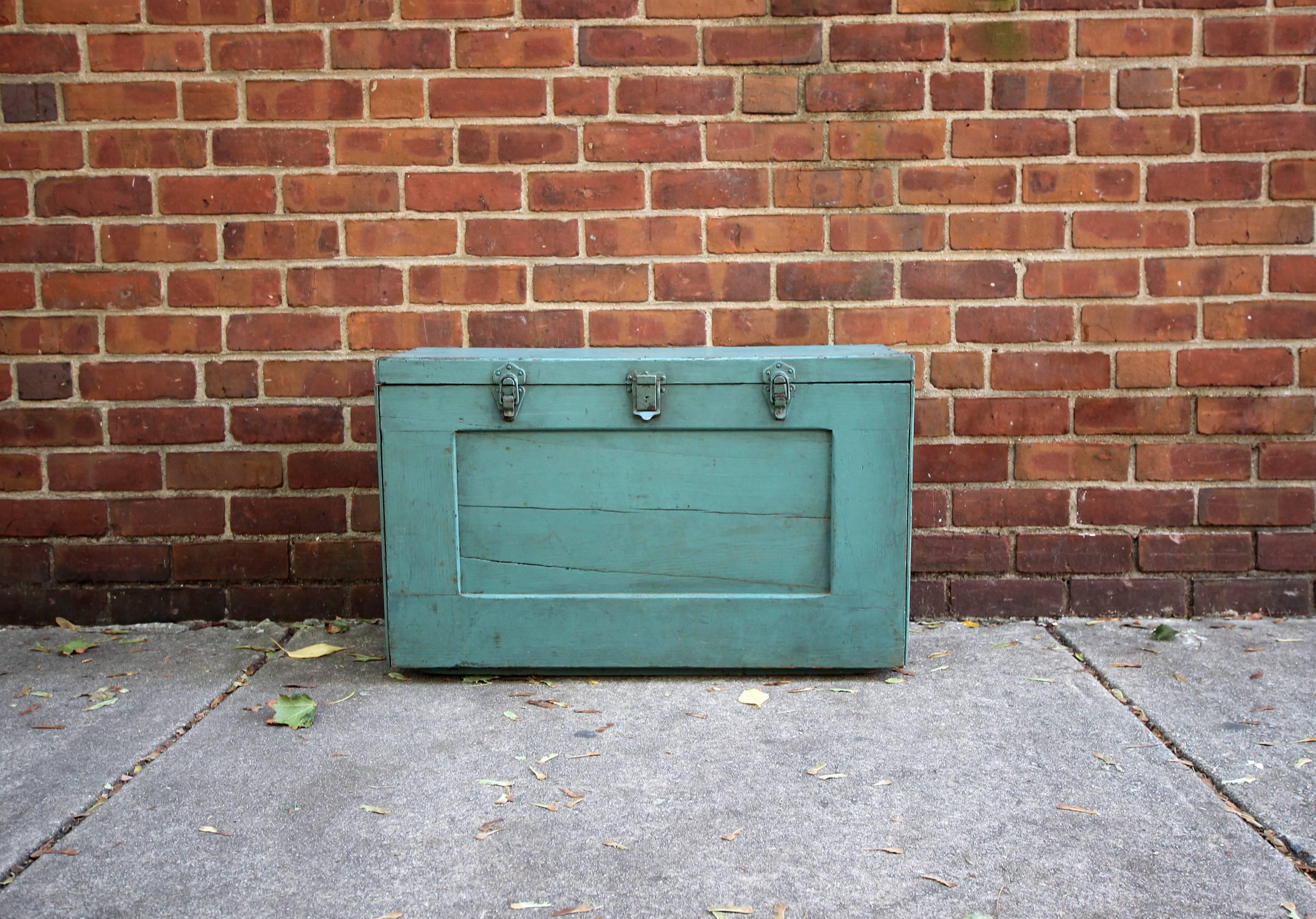 Large, heavy tool chest in original blue paint with two handles, five latches, three slots and four drawers, batten feet and paneled front. Great interior. Would make a good table. American, mid-20th century.