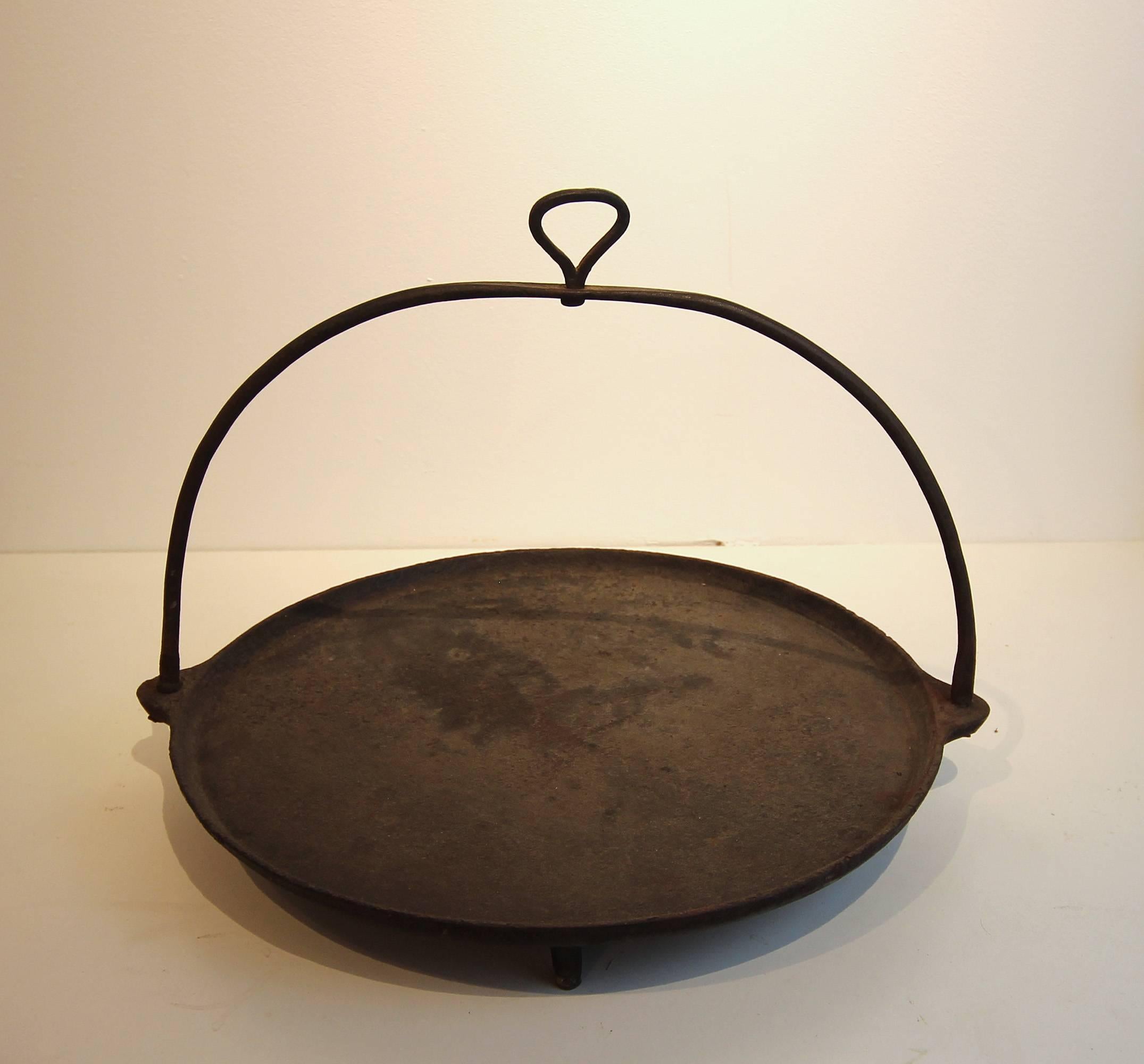 Hanging fireplace skillet with feet, cast iron, would make an excellent tabletop item in the kitchen or dining room, American, late 19th century.