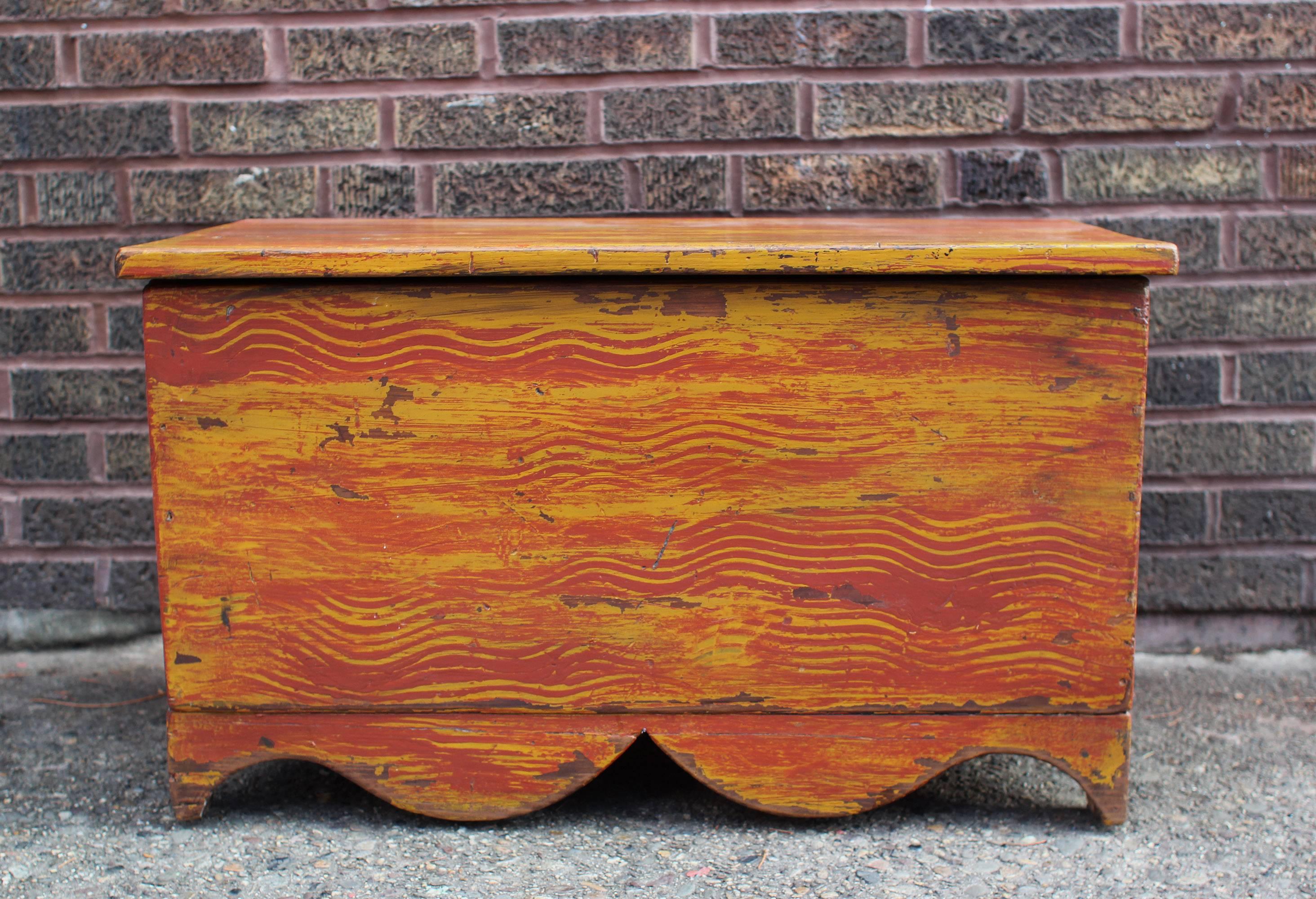 Handsome chest with excellent exaggerated cutout apron and nice lines. Old ochre and red paint decoration on all four sides, over long leaf pine. On the smaller side but very well made and sturdy, this chest is nicely versatile; it would work well