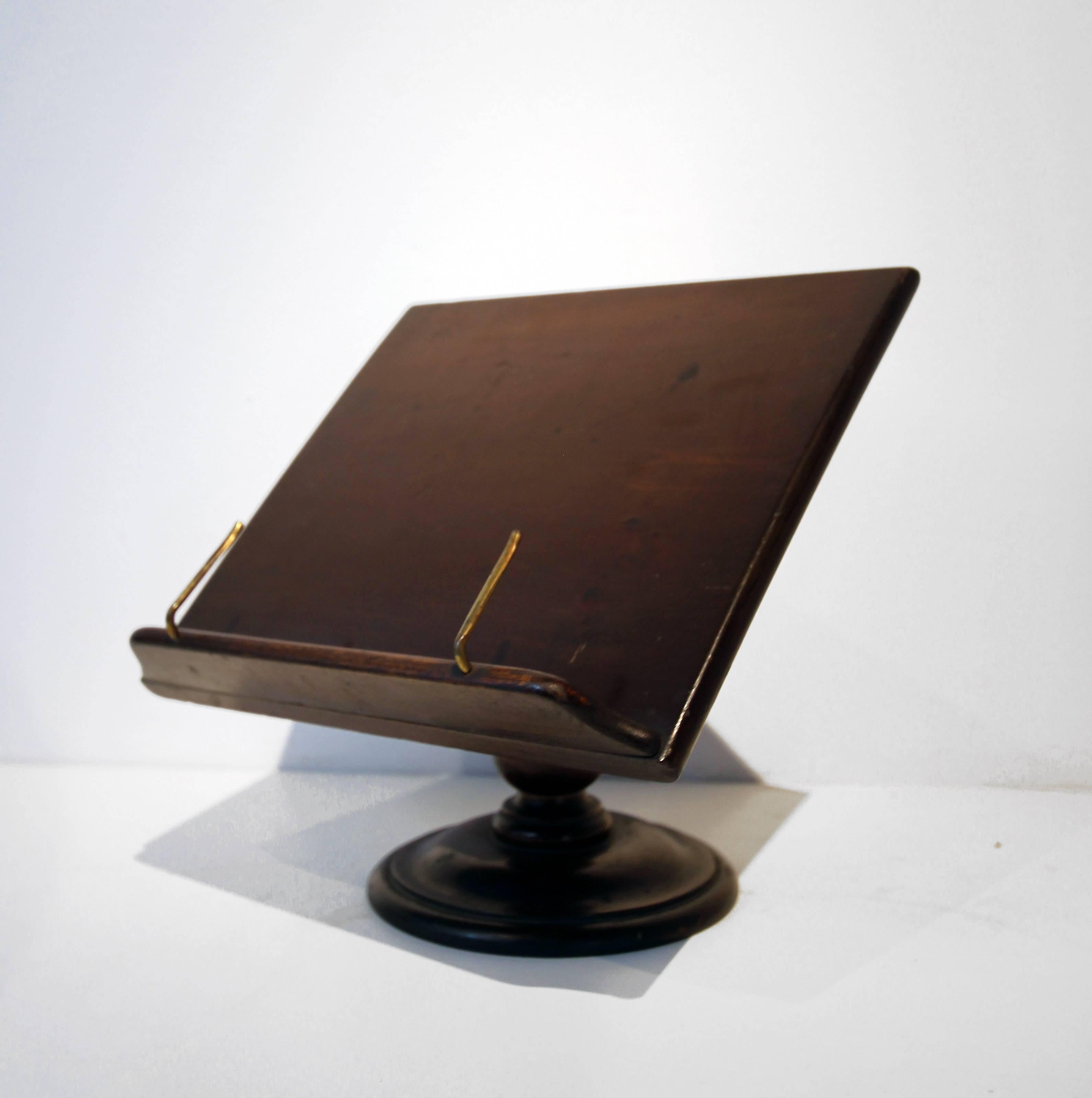 Table or desk top book lectern for holding and displaying books - great for cookbooks (or iPad) in the kitchen. Handsome mahogany wood, two parts, turned base. Original brass book holder parts. Very well made. English, late 19th century.