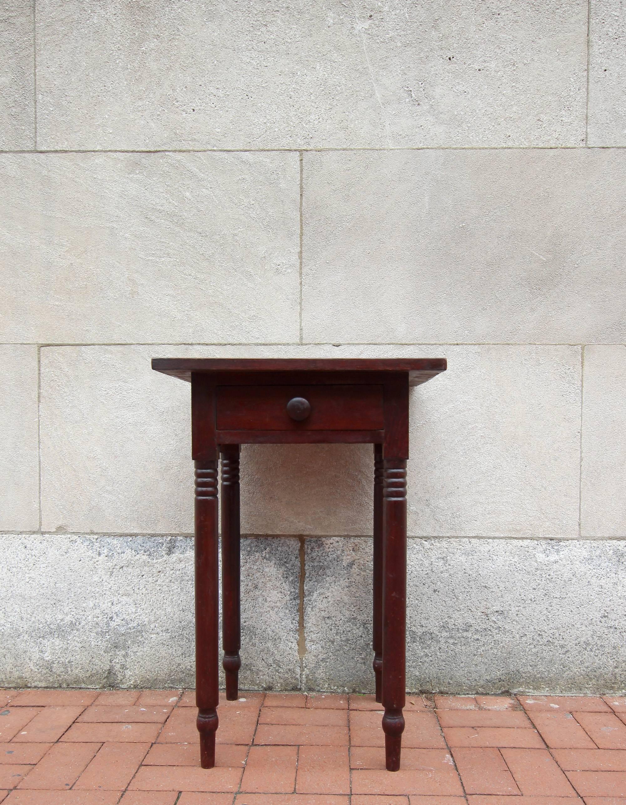 One drawer stand in a rich, dark reddish original stain, handsomely turned legs and dovetailed drawer. Original knob. Probably Pennsylvania, circa 1840.