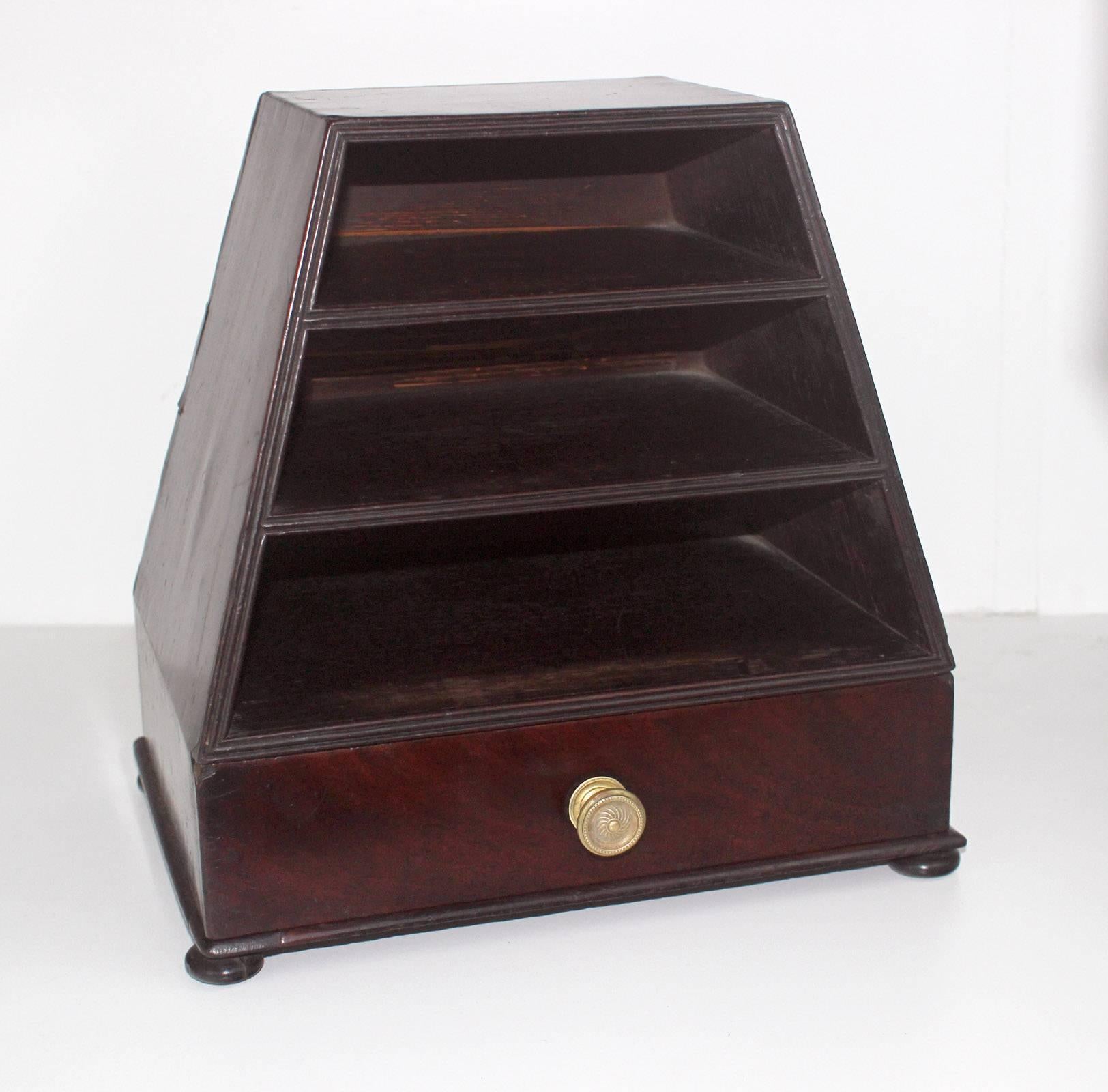 This highly unusual form was likely a desktop letter box, with three shelves and a drawer; nice bun feet, reed detail to front edge, original knob, mahogany wood. Fine dovetailed construction to drawer. Rich color to the mahogany. Excellent