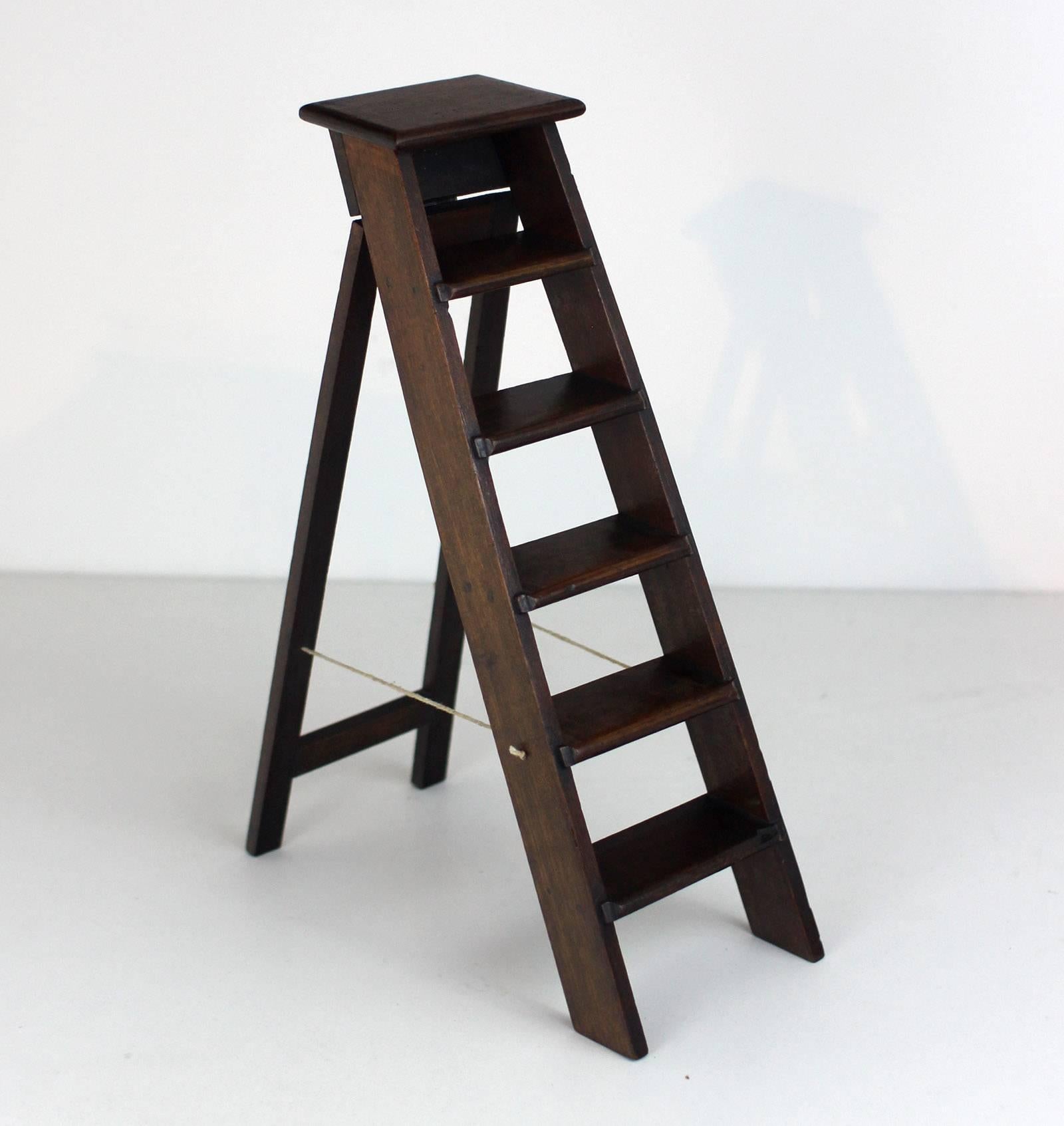 Handsome miniature mahogany step ladder, skillfully constructed with carved, dado-joined steps and hinged rear side. Likely a salesman's sample. The string has been replaced. English, 19th century.

**The noted depth is the dimension of the opened